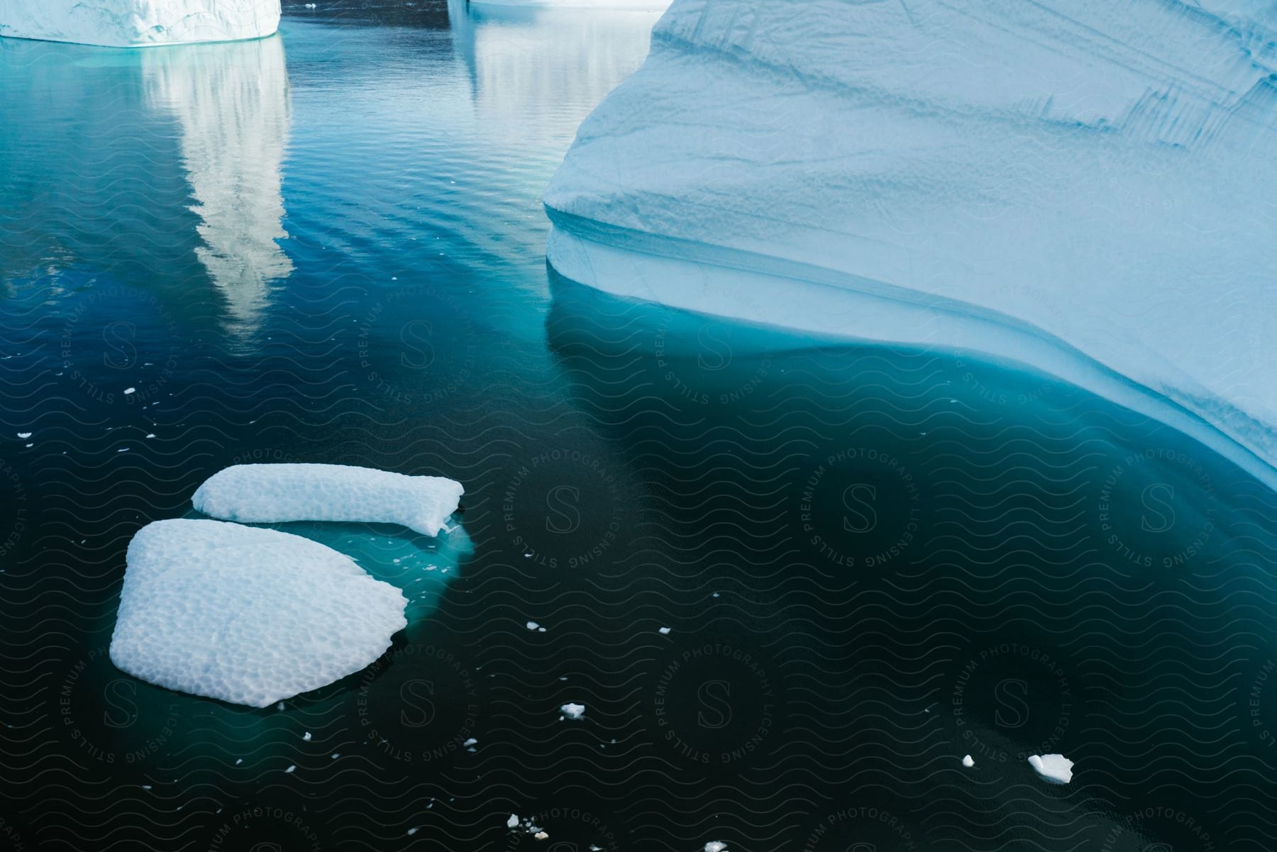 Stock photo of aerial of the ice caps on the coast of the blue sea