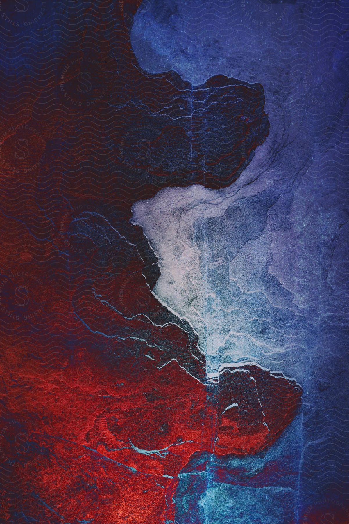 Abstract art of a blue sea with red mountains.