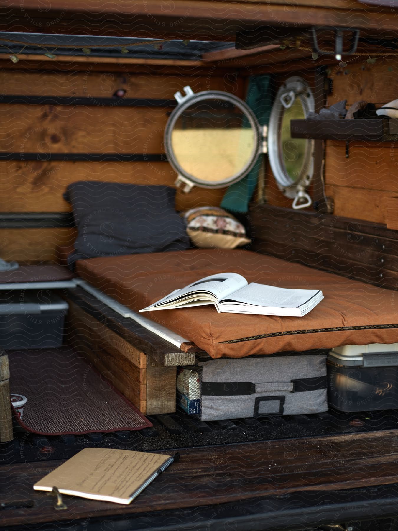 Interior design of a small space with a mattress, pillow, and a book.