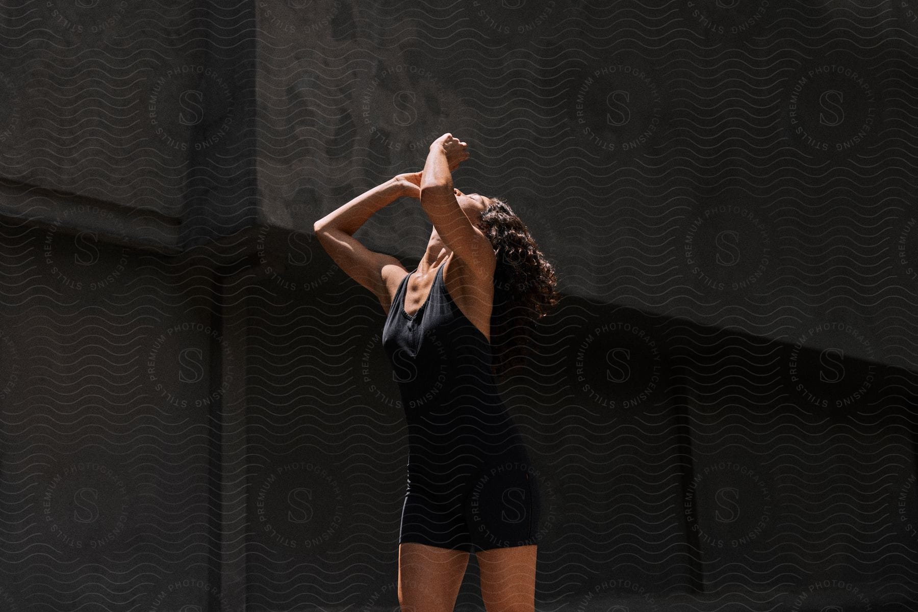 Woman with hands up wearing a black dress