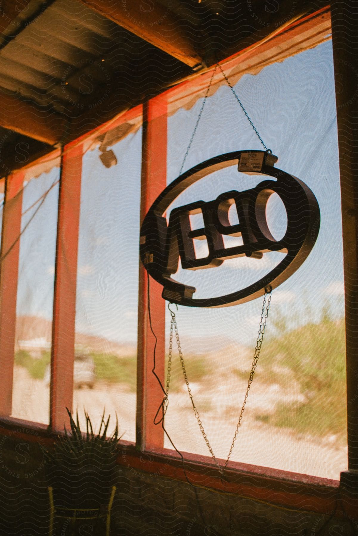 An open sign in the middle of a store on a sunny day.