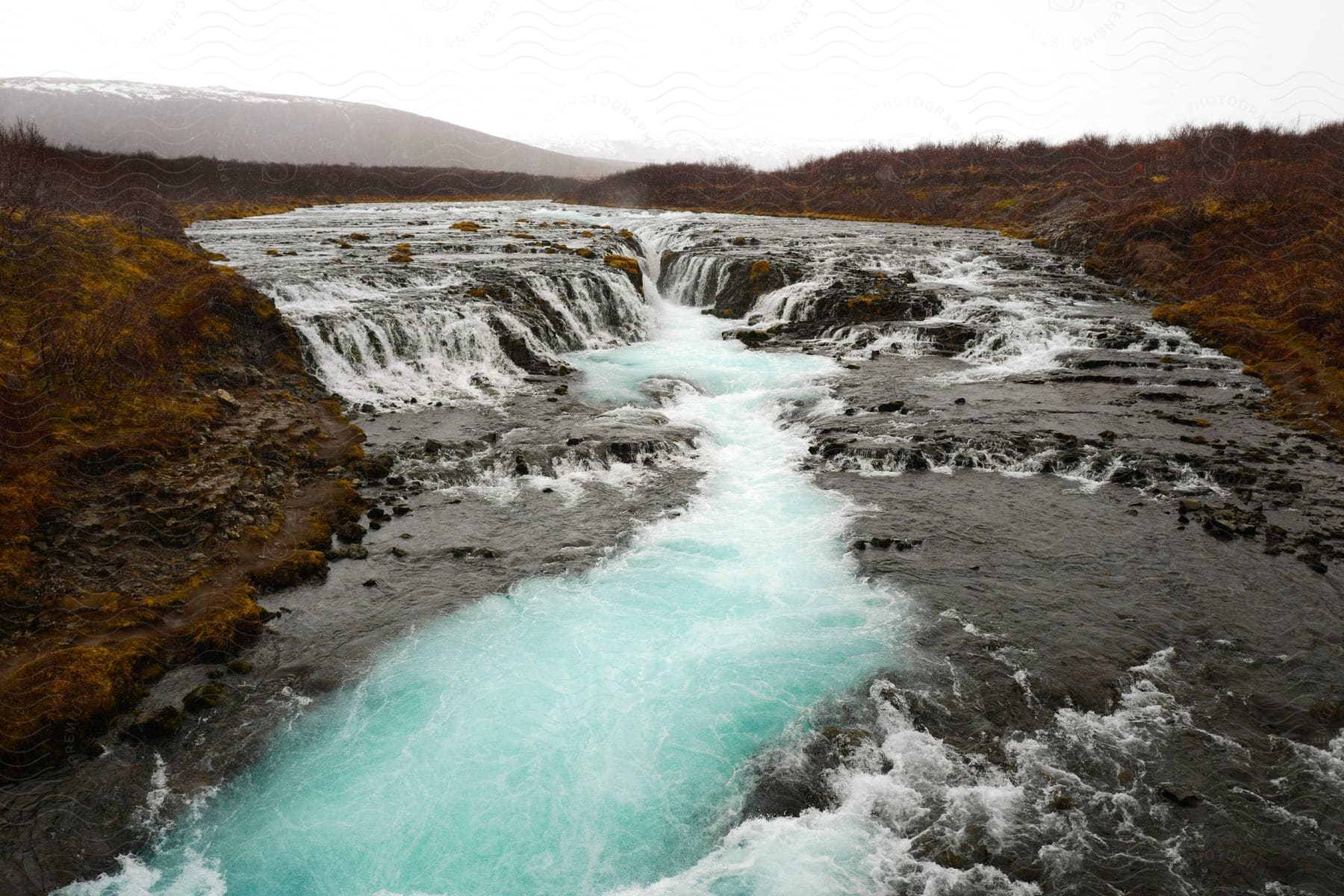 A river with some waterfalls out in the middle of nature