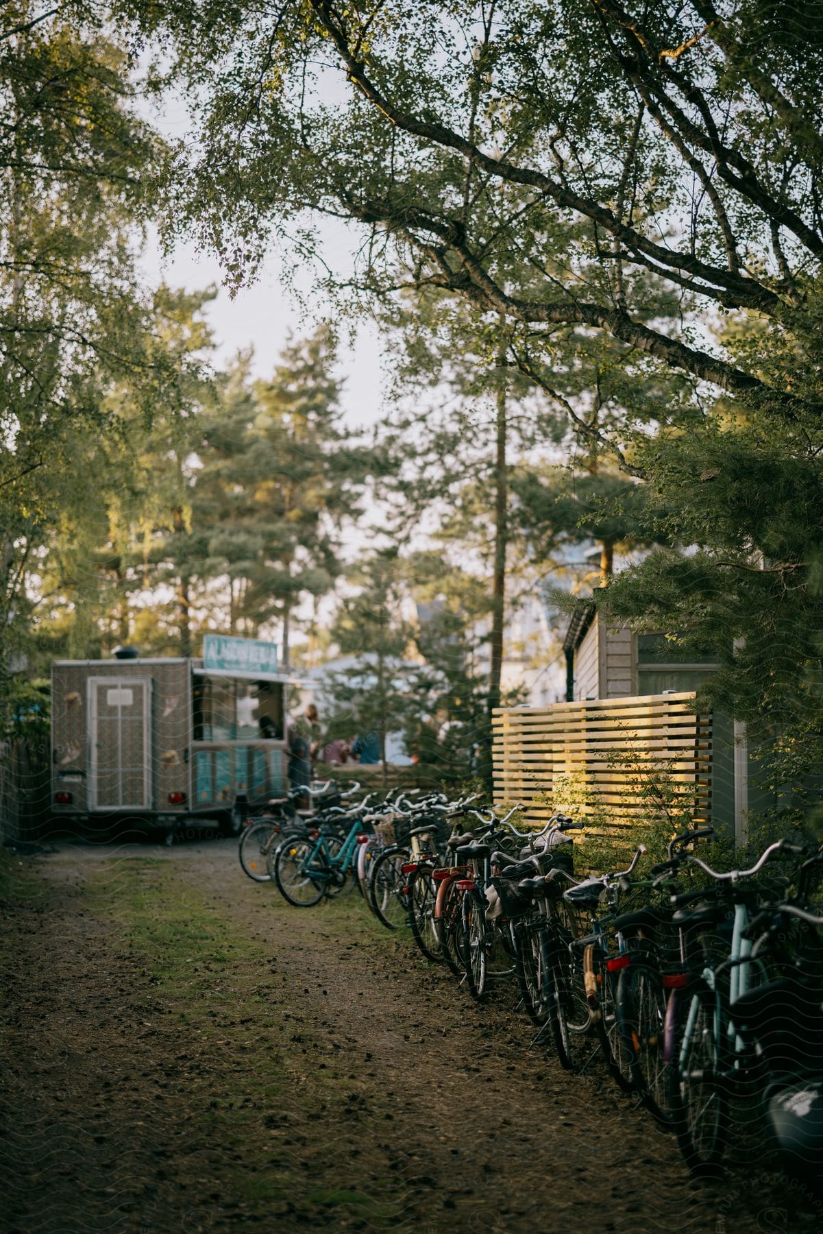 bicycles are lined up along a small fence