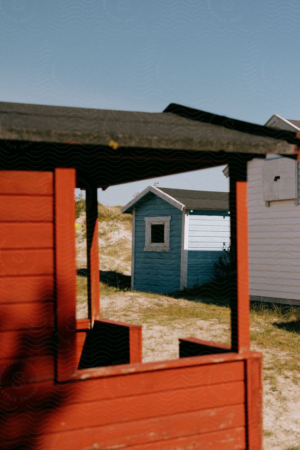 tiny homes and sheds sit close together in a gravel lot