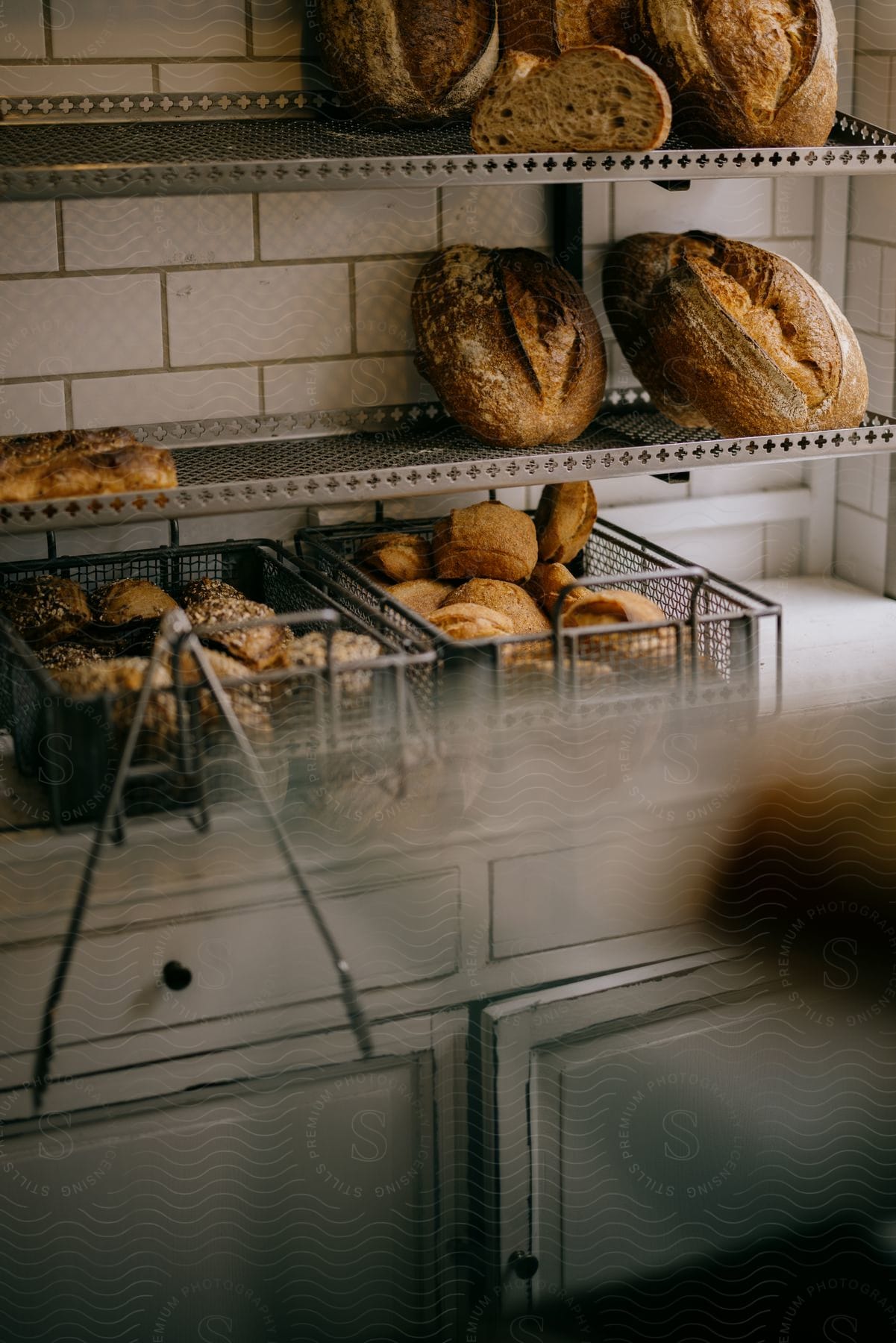 Freshly baked bread rest on racks in the kitchen wall