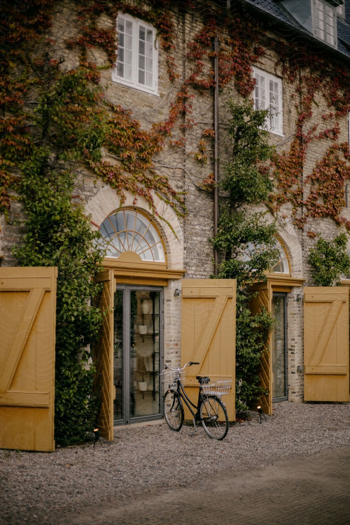 A view of a sidewalk with a bike on it next to some buildings.