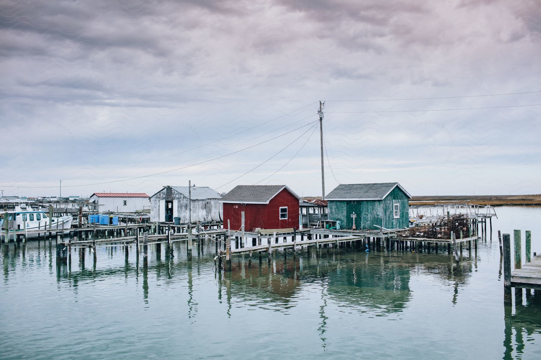 Houses of different paint and exterior are built above water and each house is attached to a pier for access to boating.