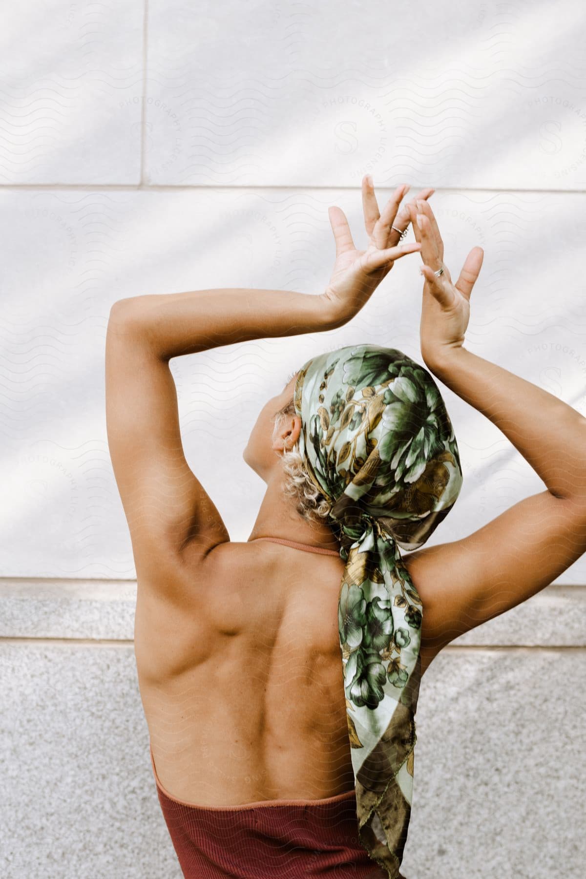 A woman doing yoga poses outdoors on a sunny day