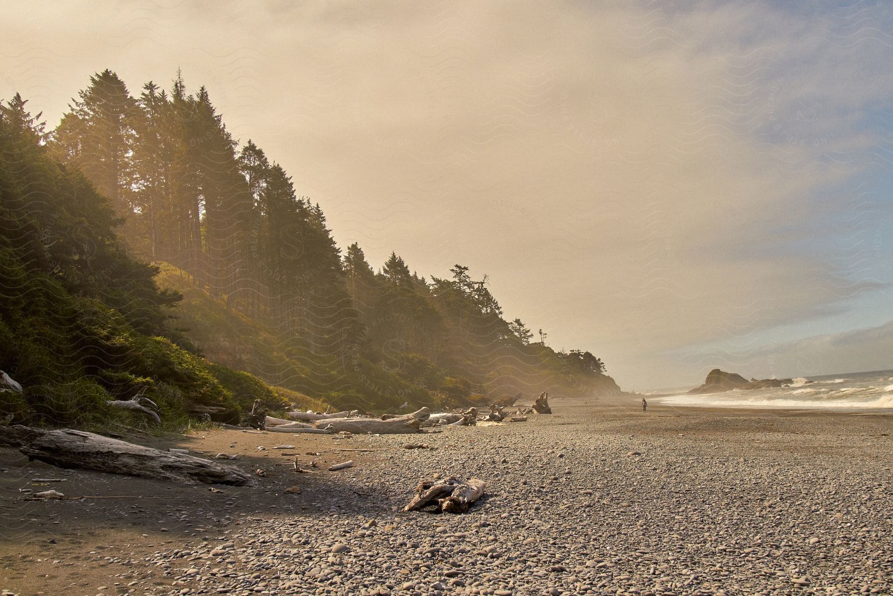 A rocky beach with waves hitting the rock in the water.