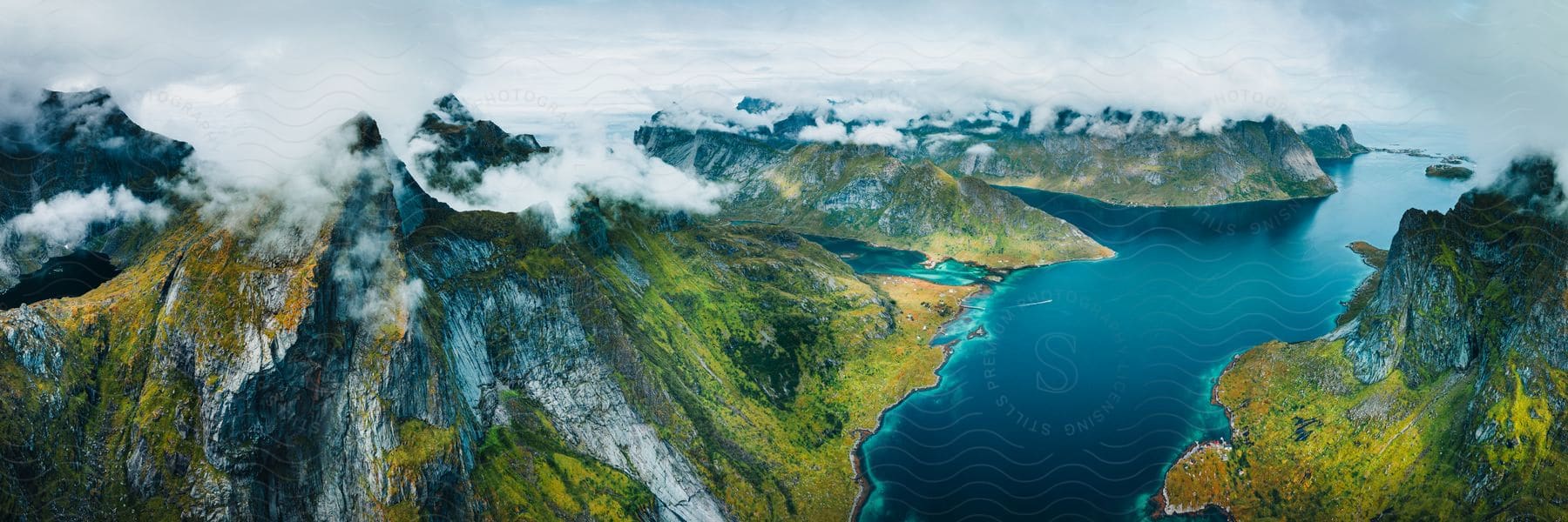 Rocky coastal cliffs near fjords on a cloudy day.