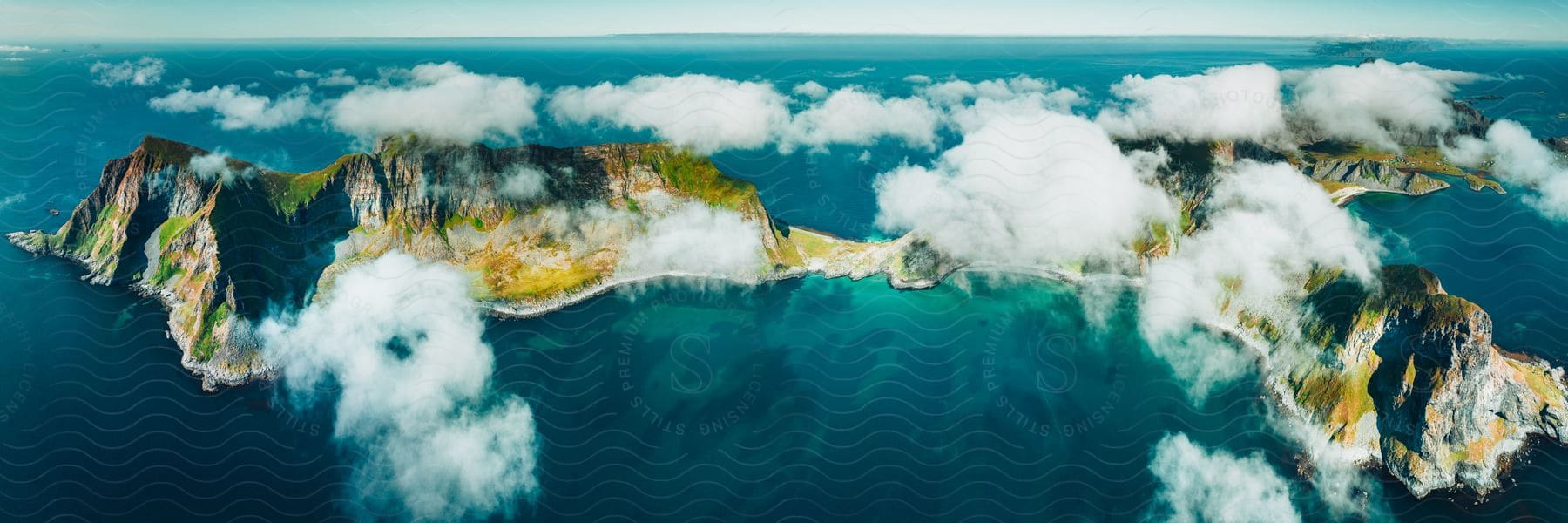 An aerial view of some islands with clouds above it