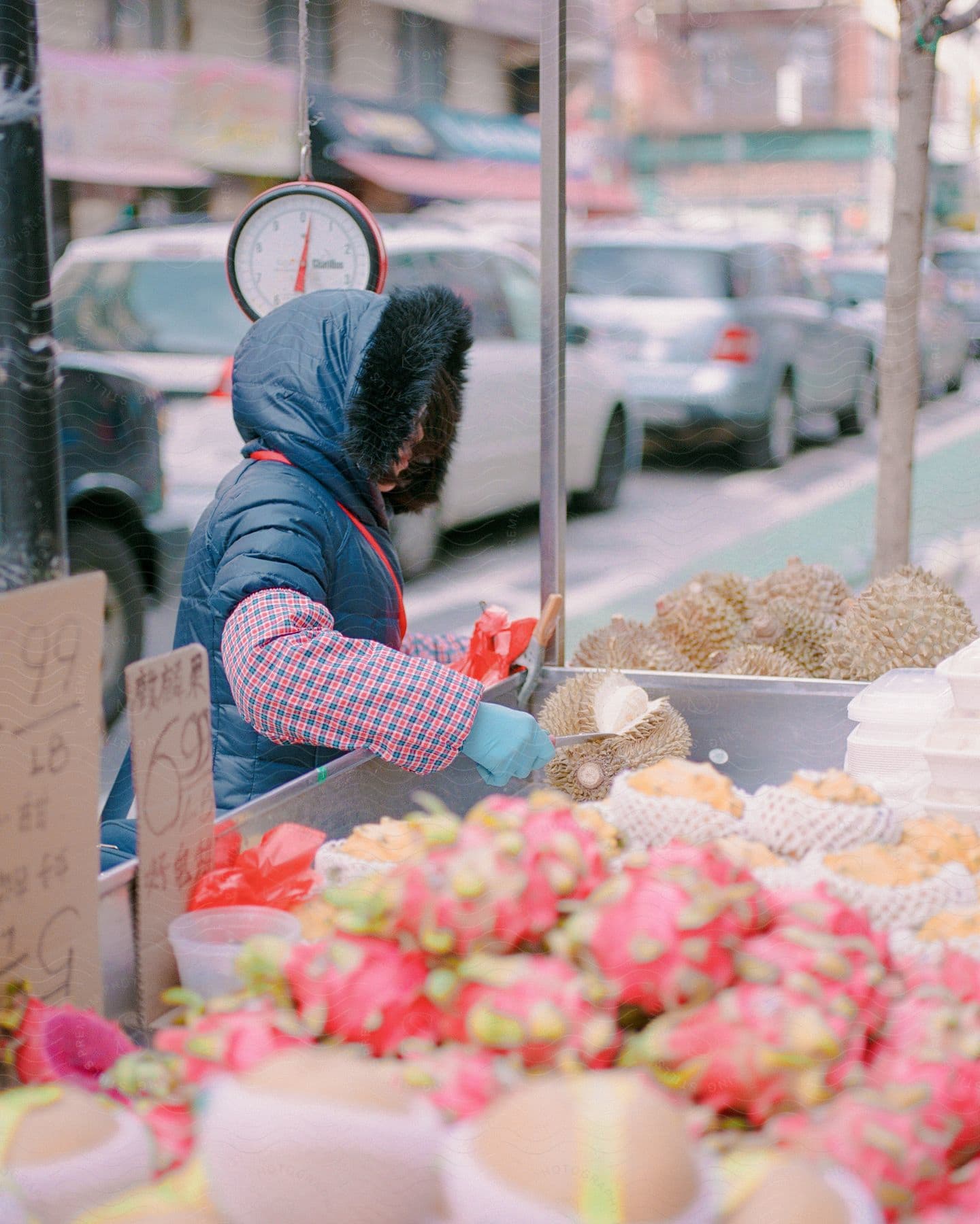 Stock photo of a woman preparing and serving up food on a street corner.