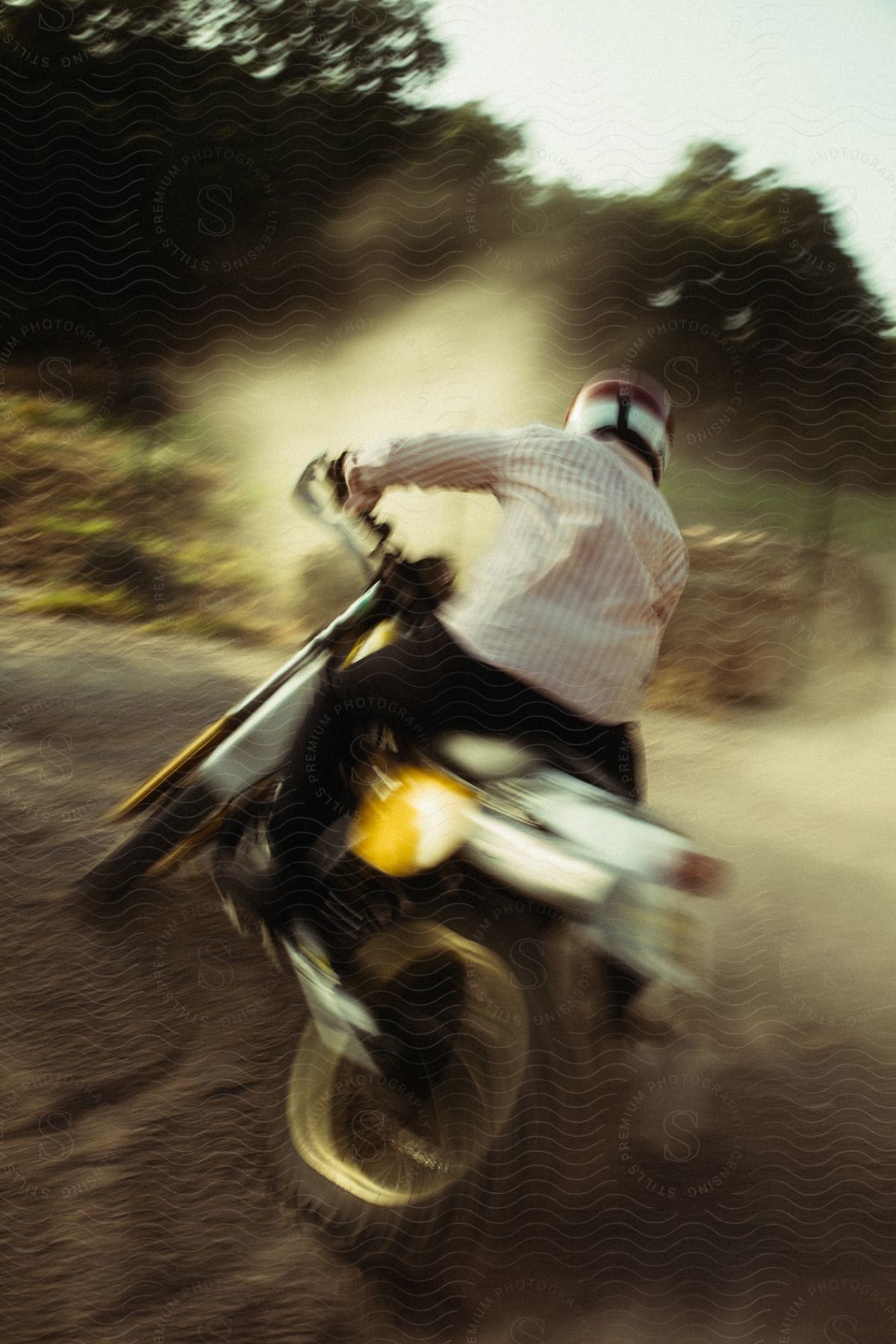 a motorcyclist rides through dirt