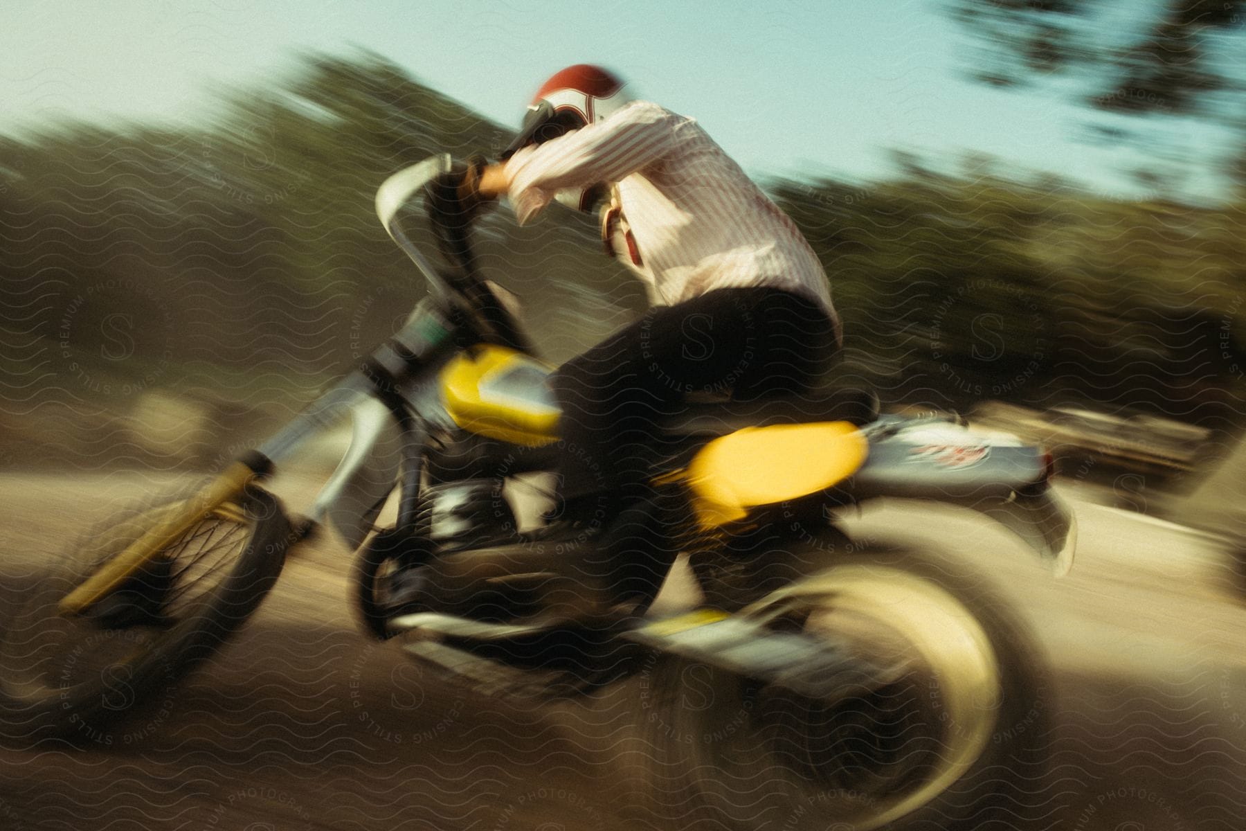 a man rides a motorcycle through a dirt field