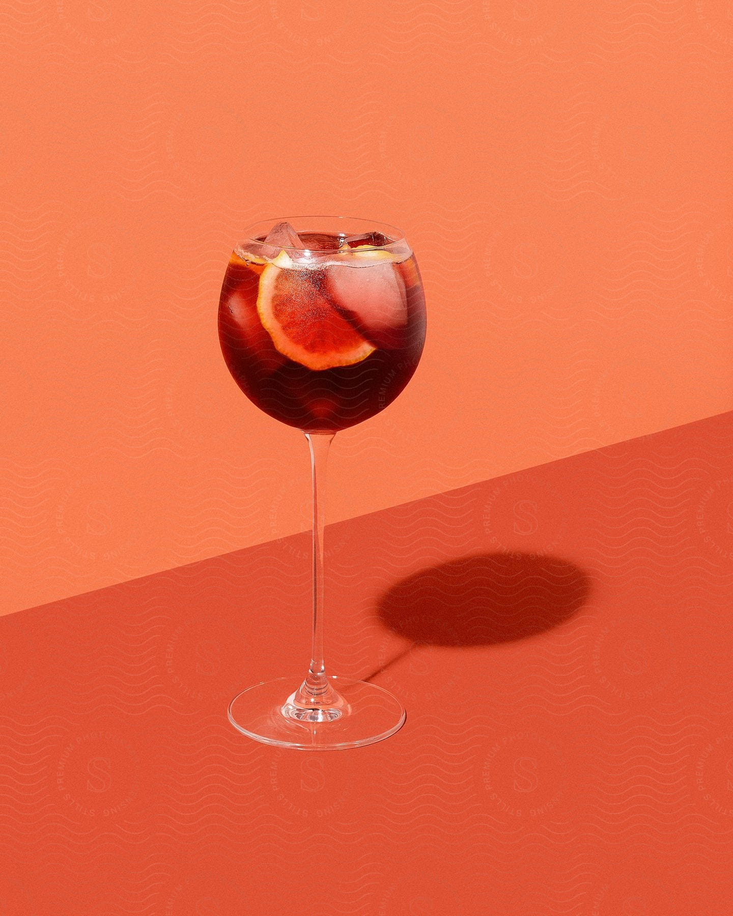 Stock photo of drink in a glass with ice and slices of orange.