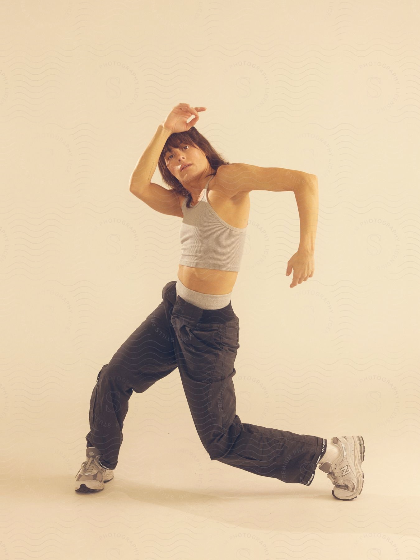 A woman posing in athletic clothes.
