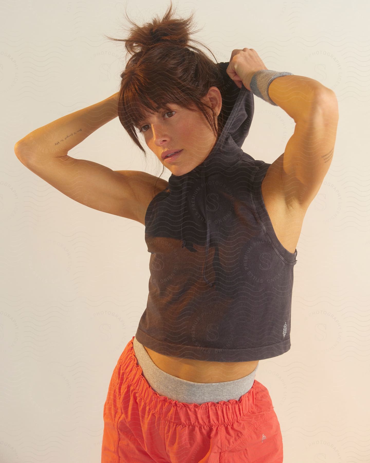 A woman posing in athletic clothes.