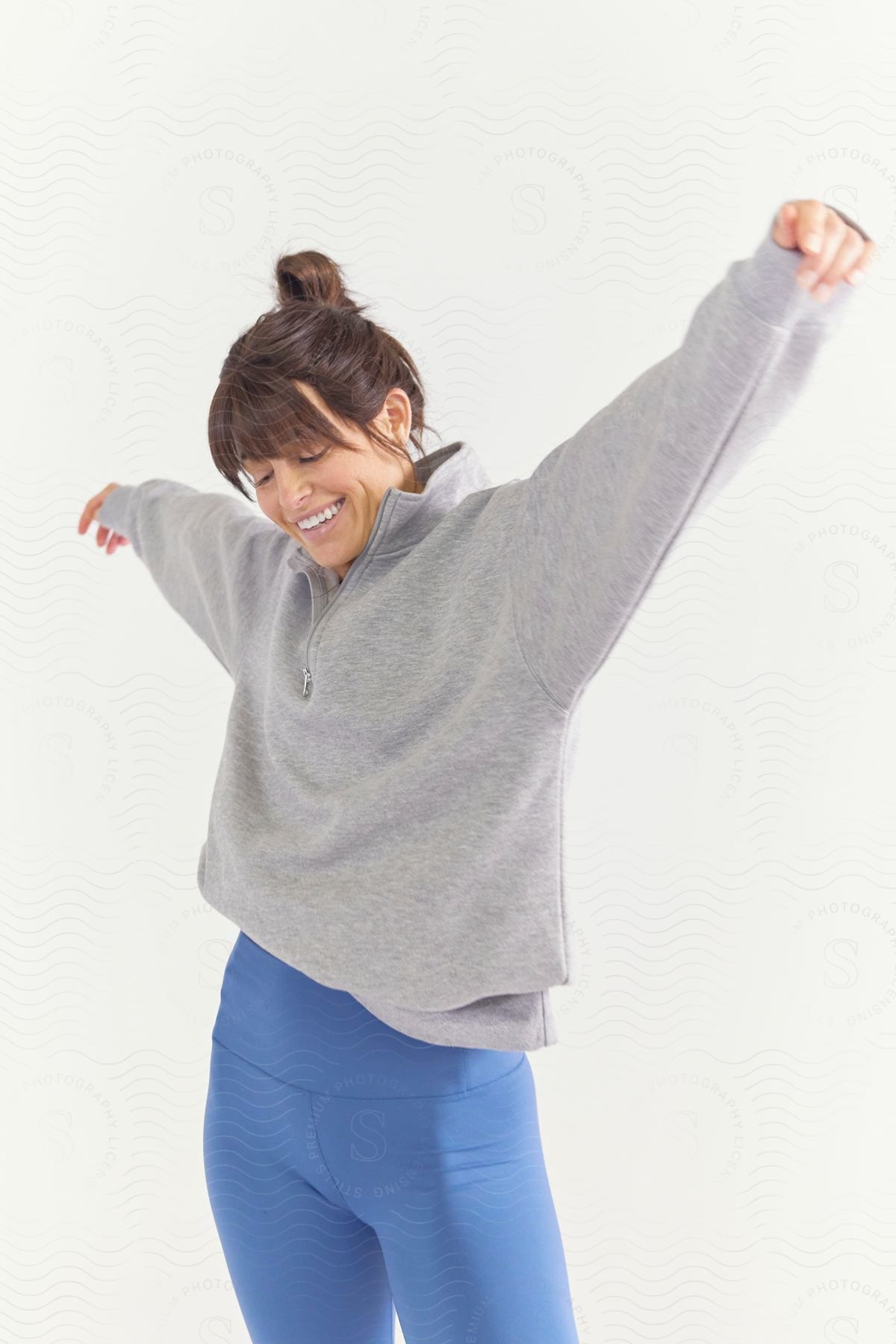 A woman modeling some clothes in a studio.