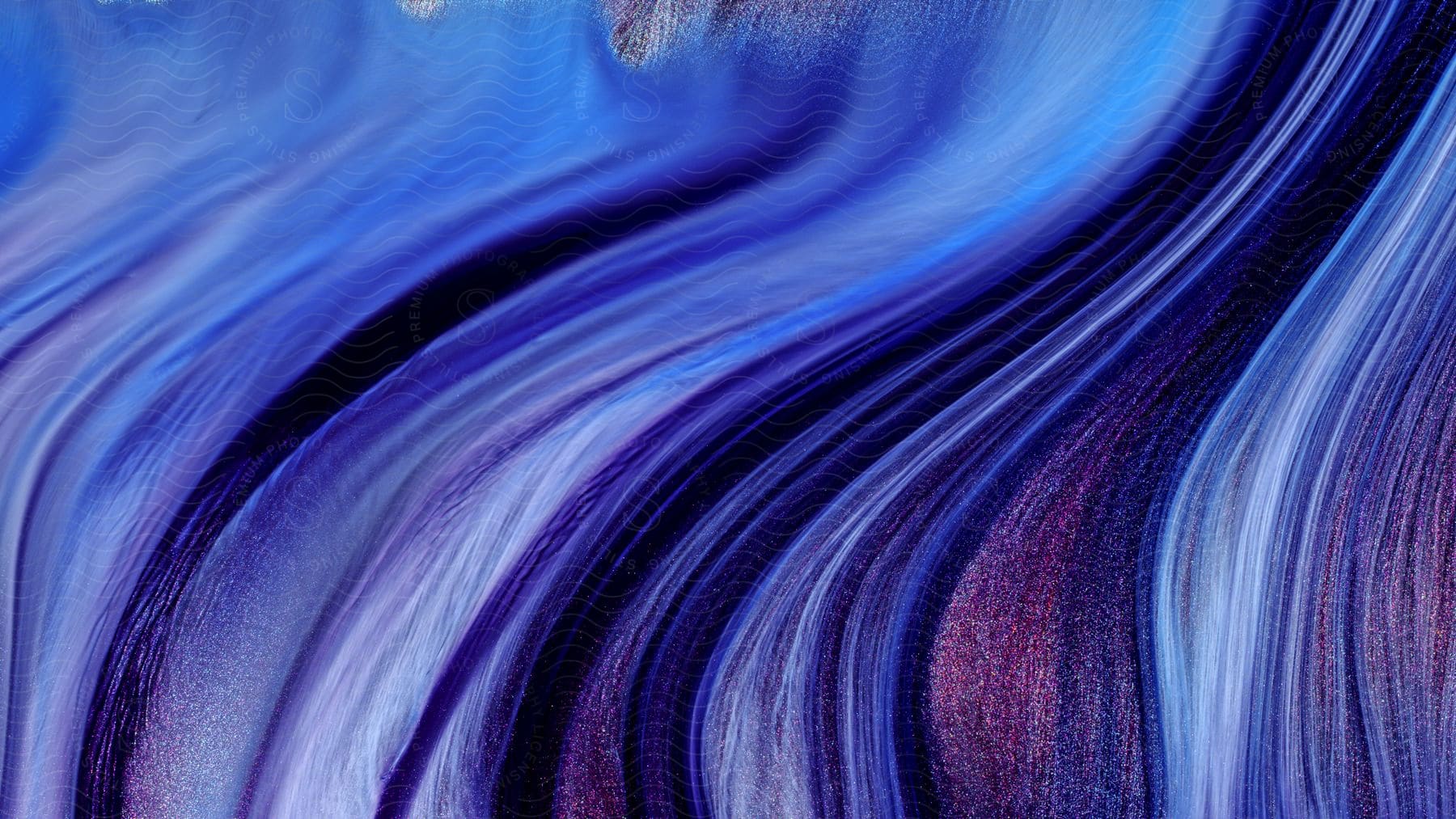 A purple and lavender fluid flows and swirls to create an artistic abstract image.