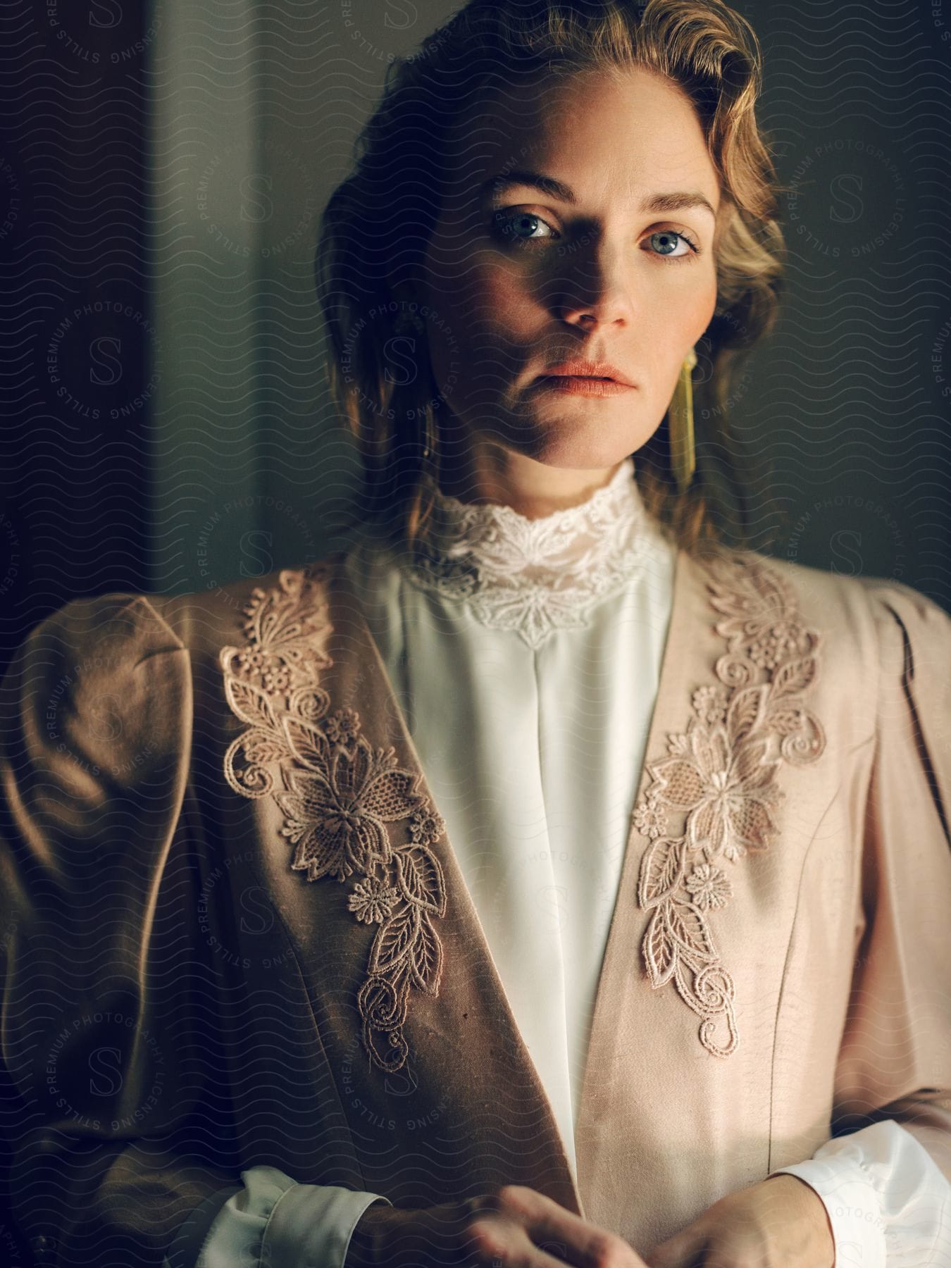 A portrait of a woman in a room with formal clothing on