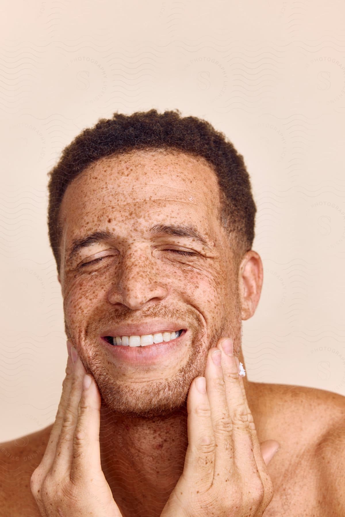 Close-up of a smiling man's face with spots on his skin.