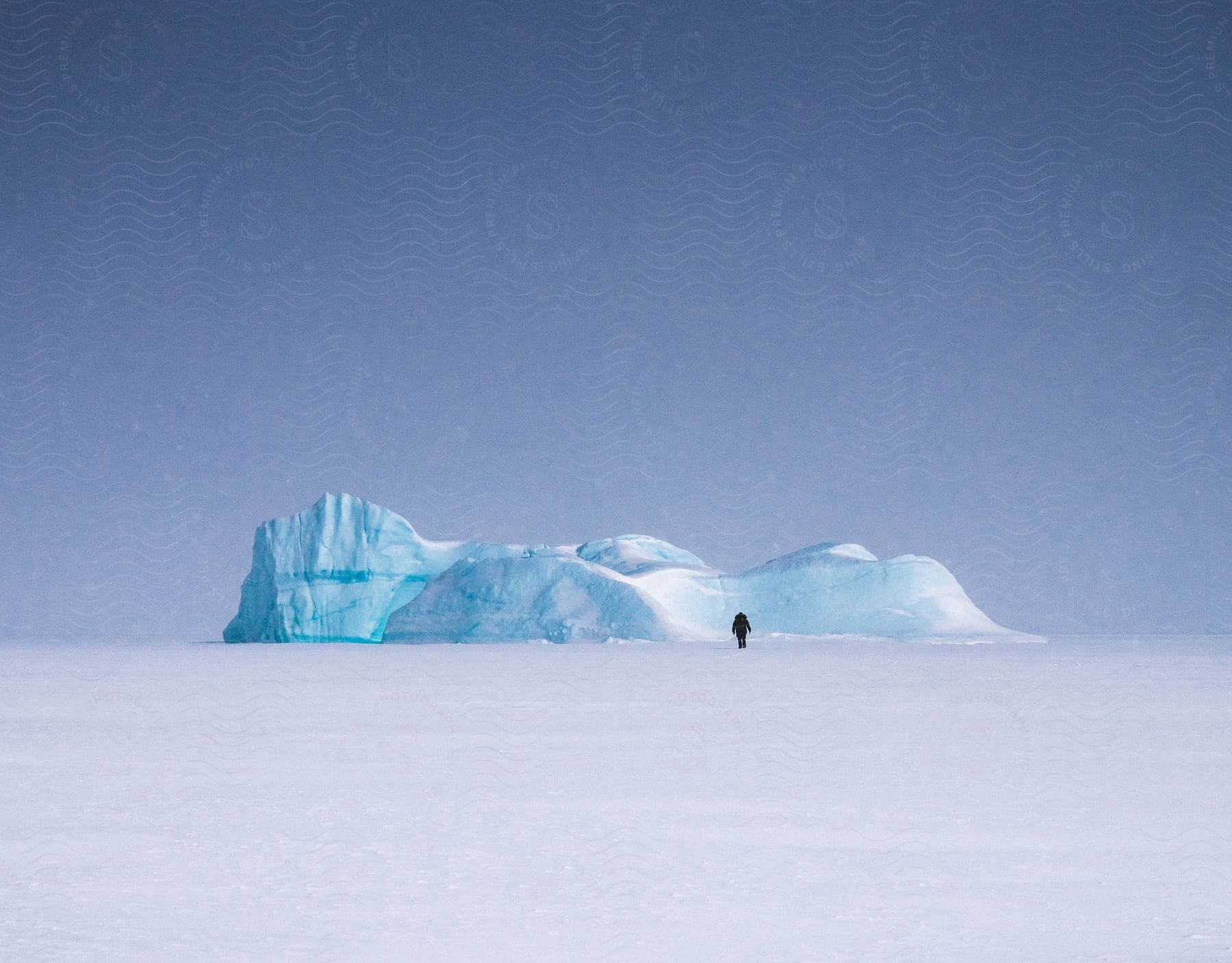 A person walking on a glacier