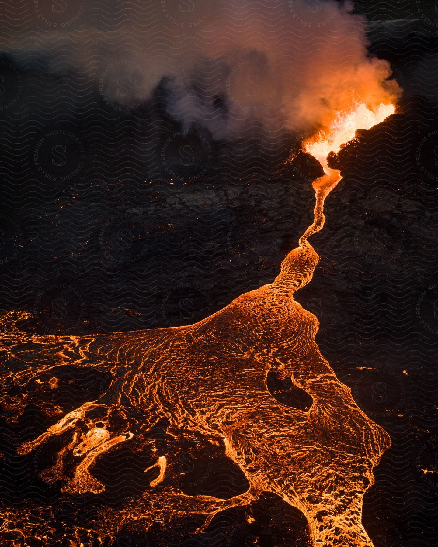 An erupting volcano with lava spilling down the mountain.