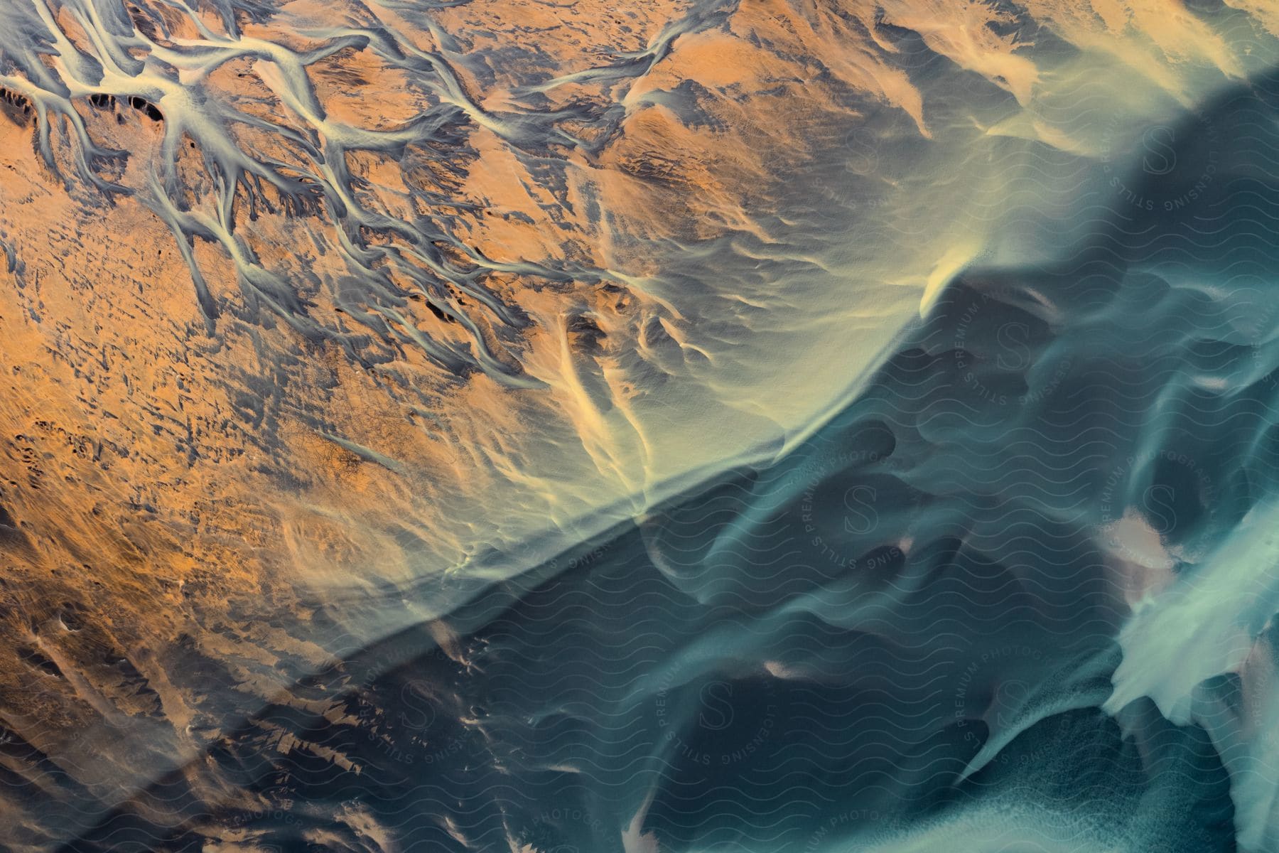 Stock photo of ocean waves roll against coast.