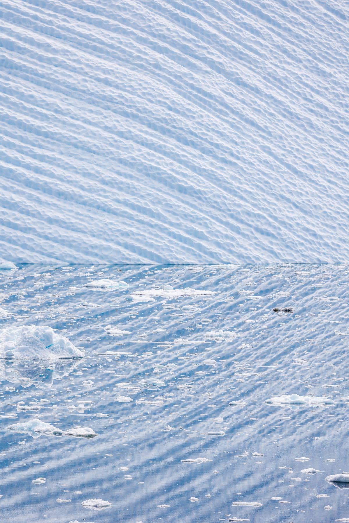 Open water with ice chunks floating.