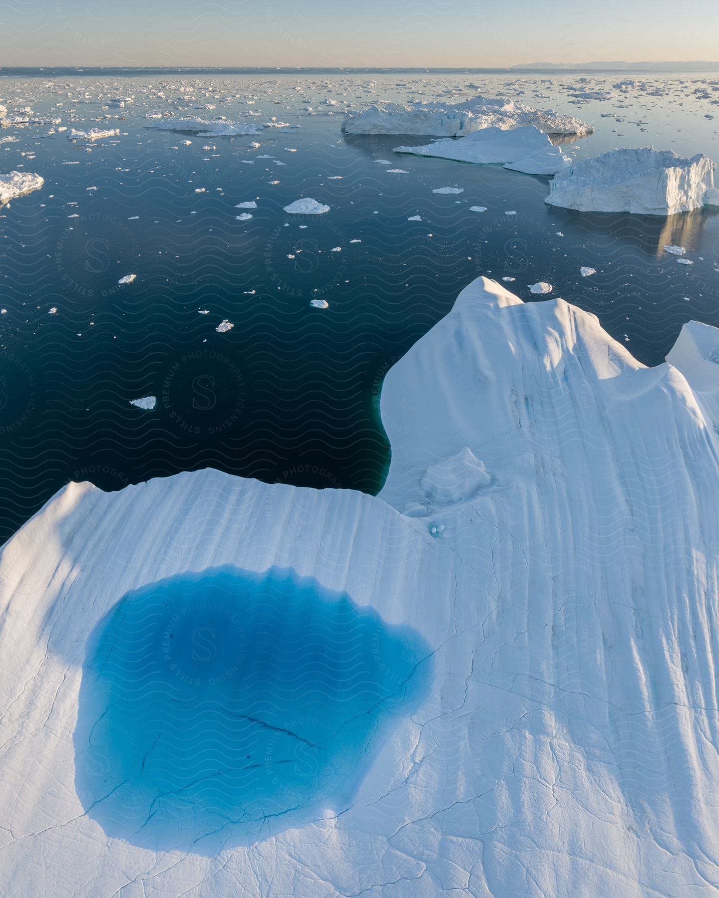 ice in different forms on water at midday