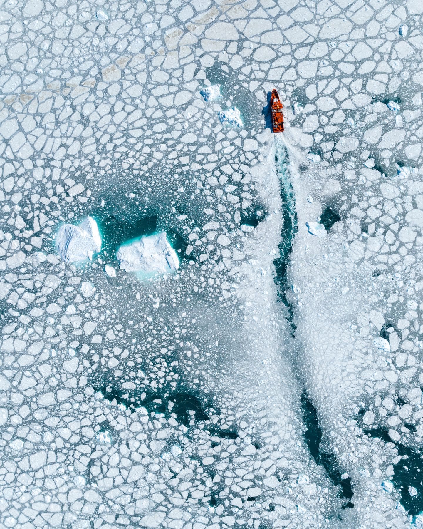 Boat traveling in a completely frozen sea.