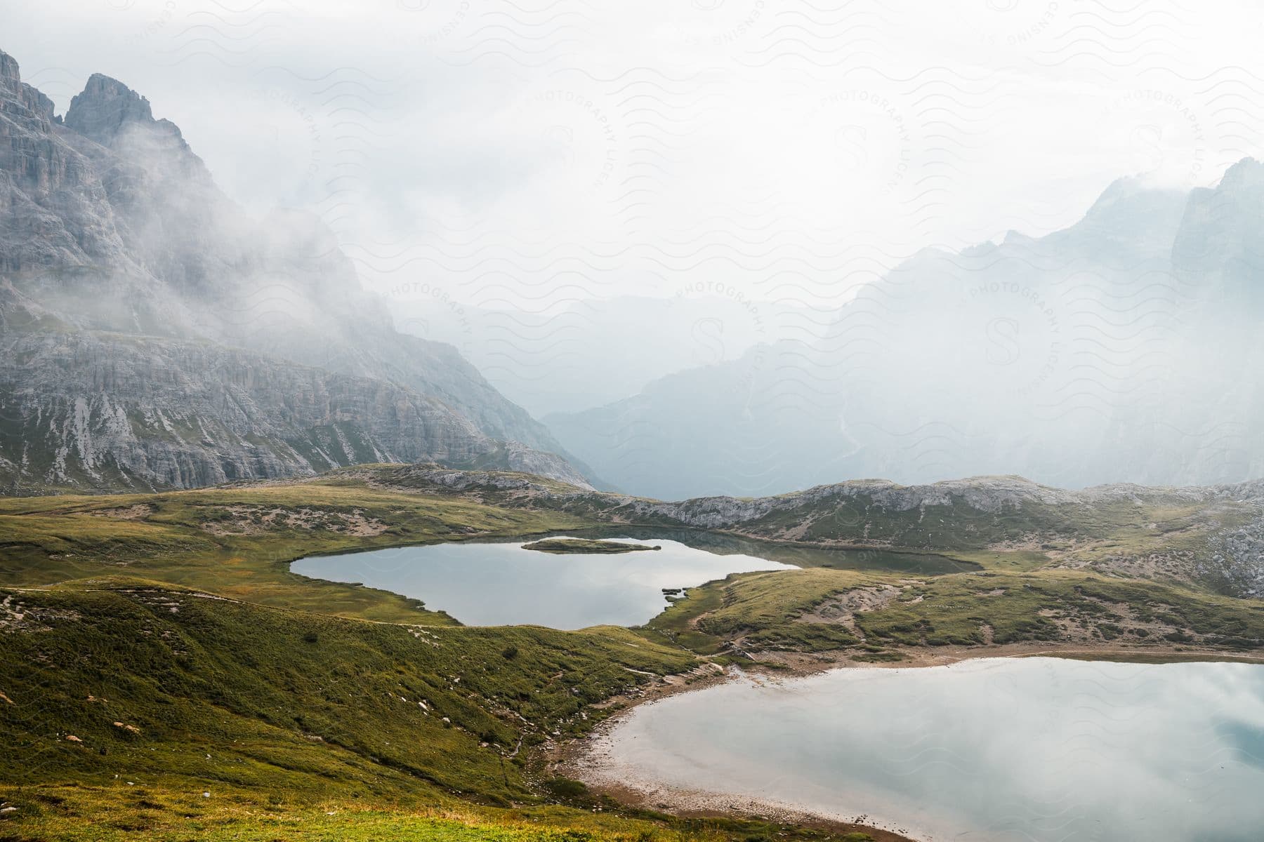 A view of some lakes out at the base of some mountains