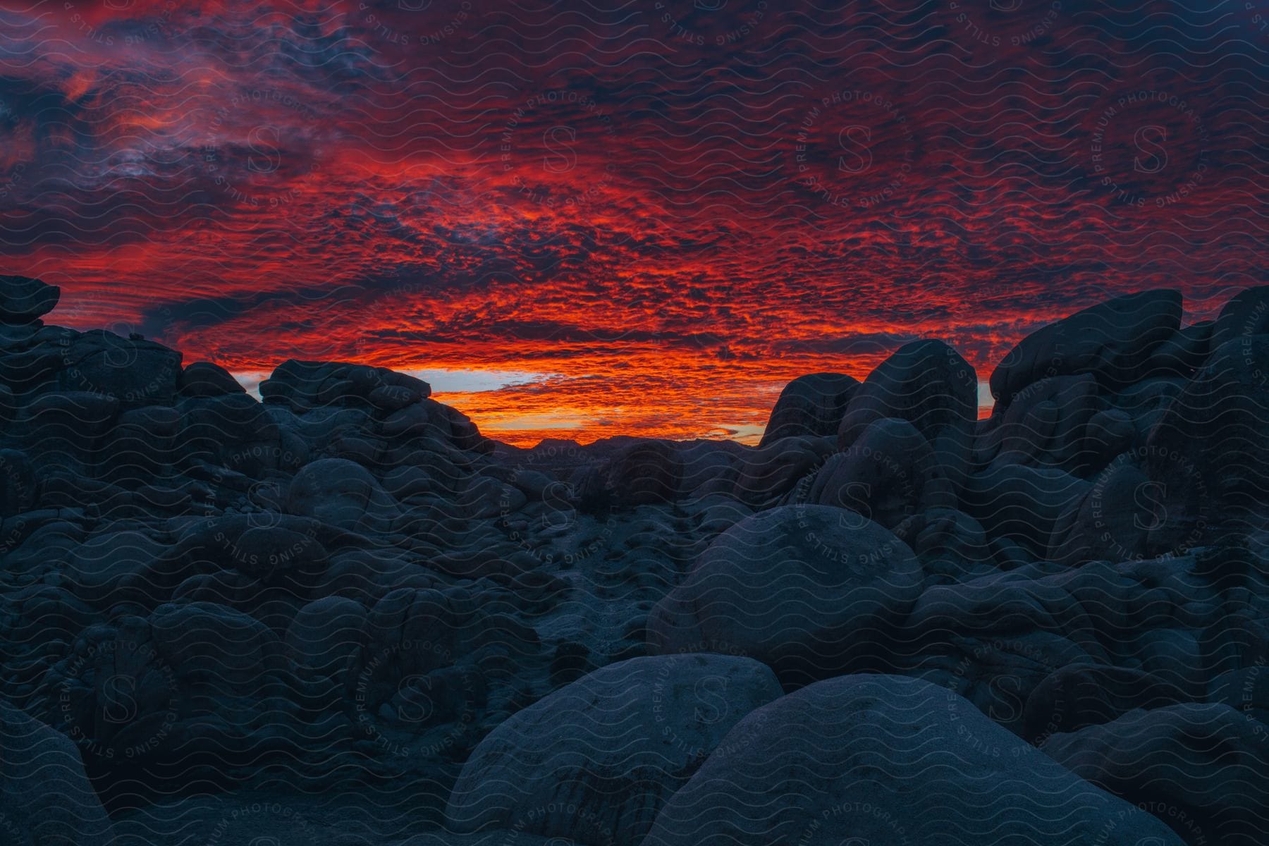 Large rocks and boulders under a cloudy sky at sunset