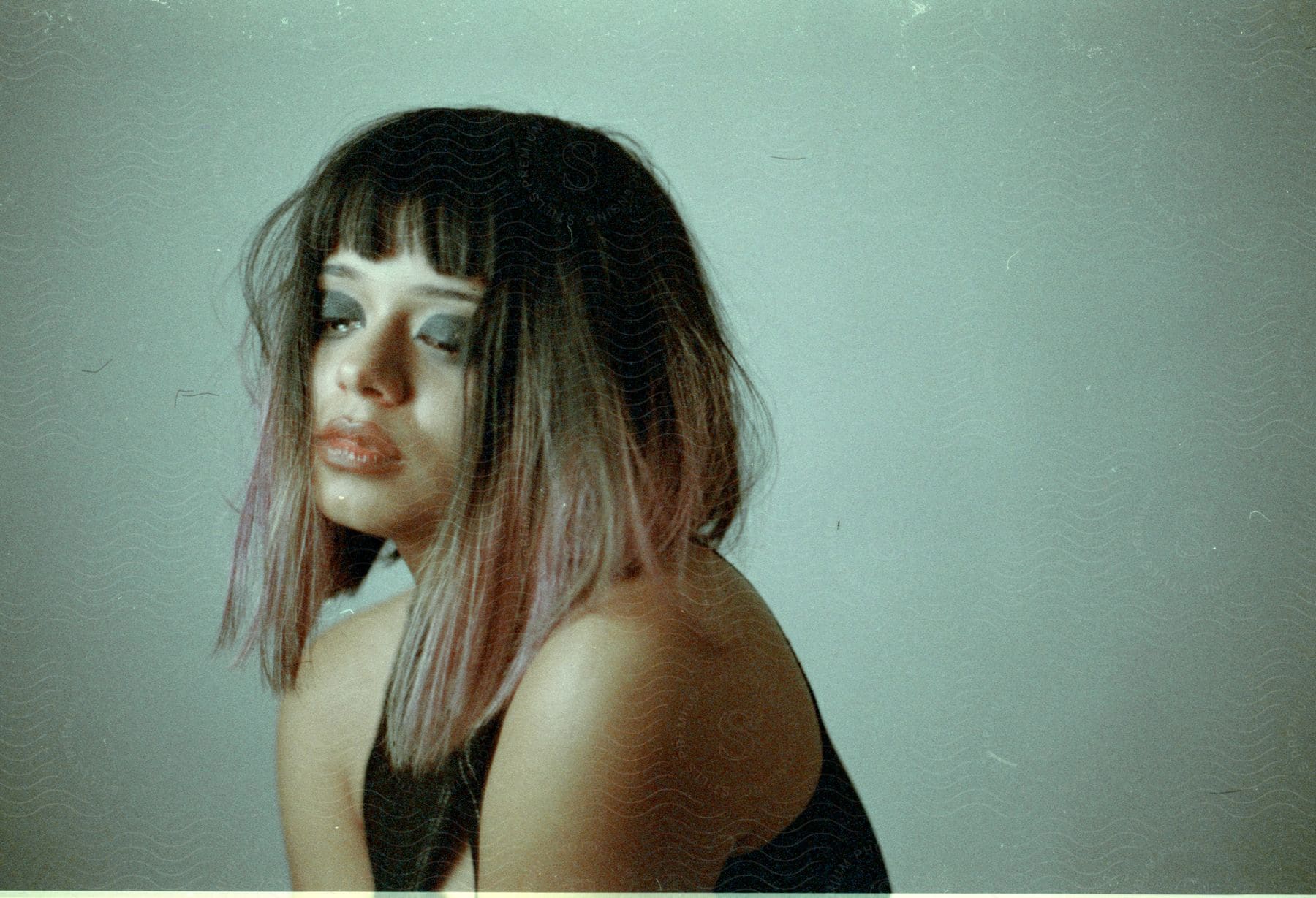 A portrait of a woman crying in a photo studio.