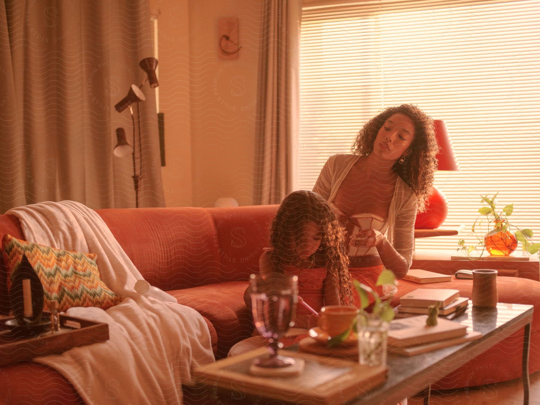 A mother and daughter sitting in a room together