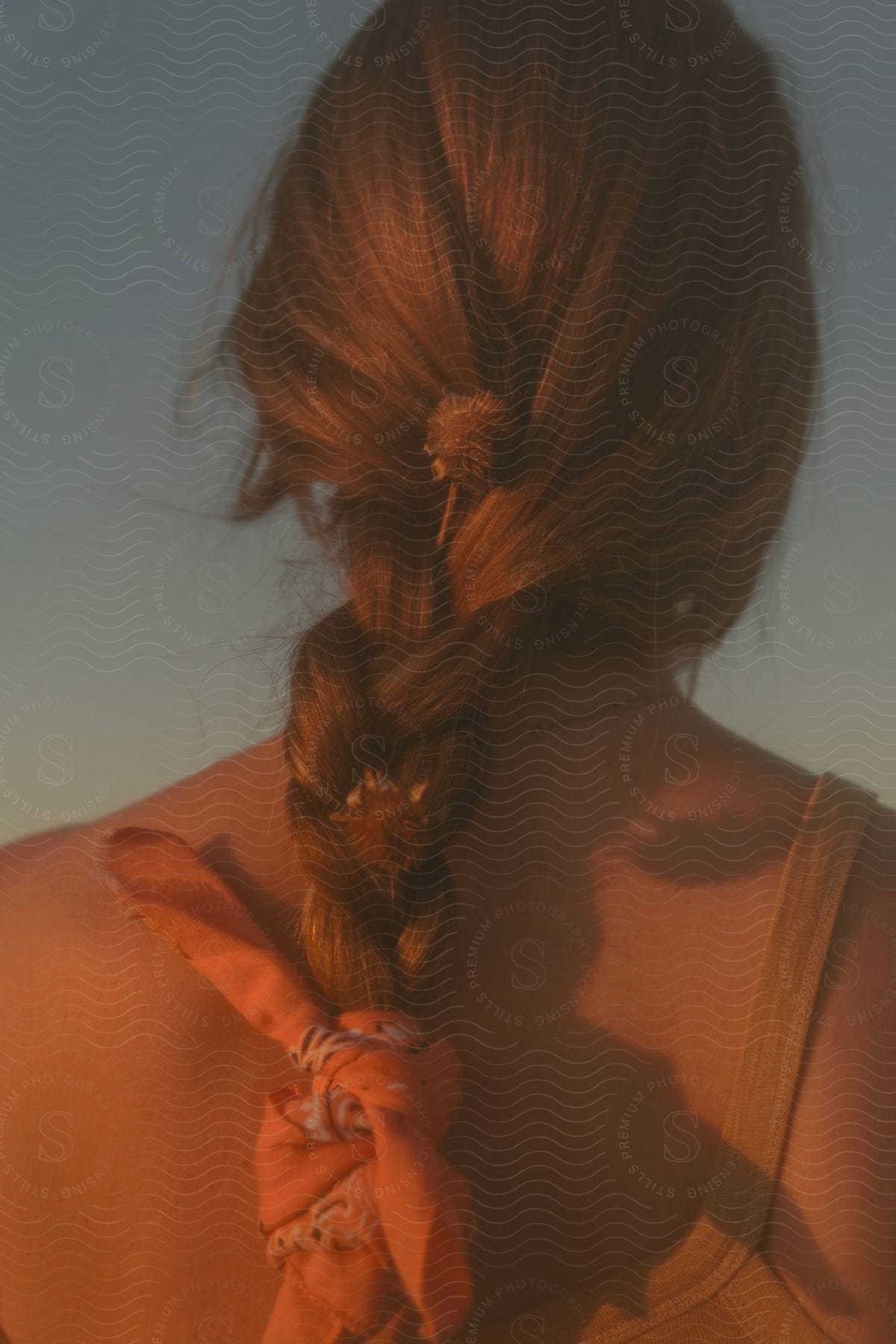 a scarf is woven into a woman's braided hair