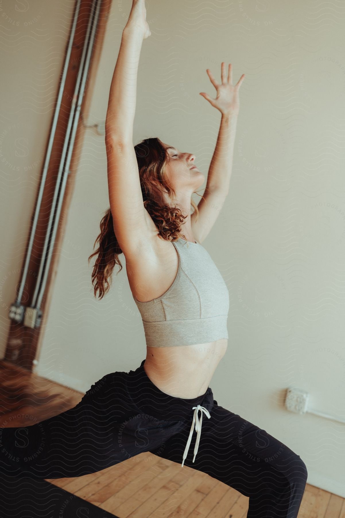 Woman lunges during a yoga pose at home.