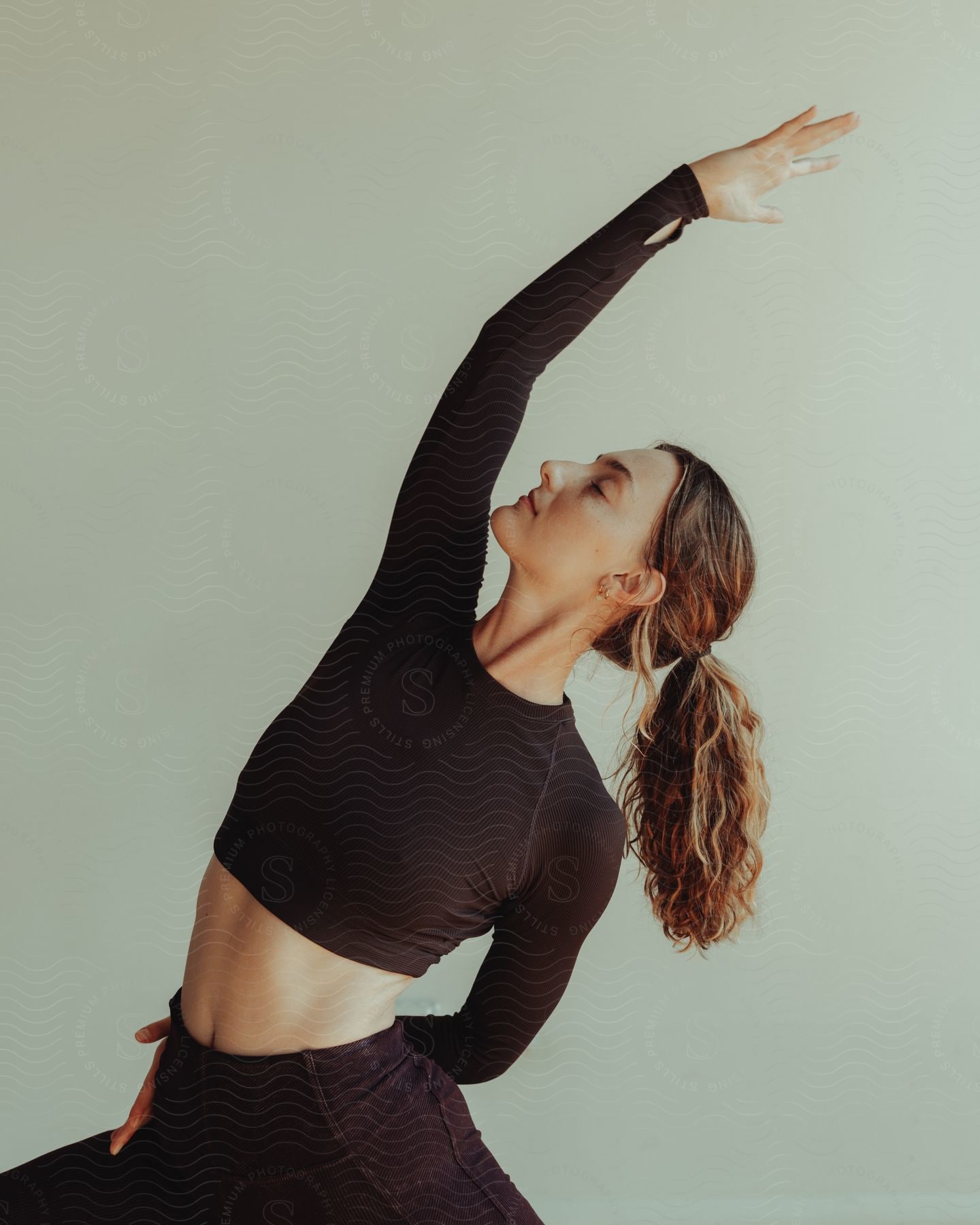 a lady doing stretch while wearing all black yoga clothes
