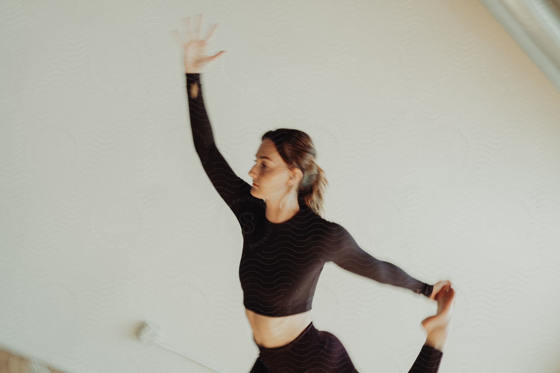 A dancer holding her foot to stretch.