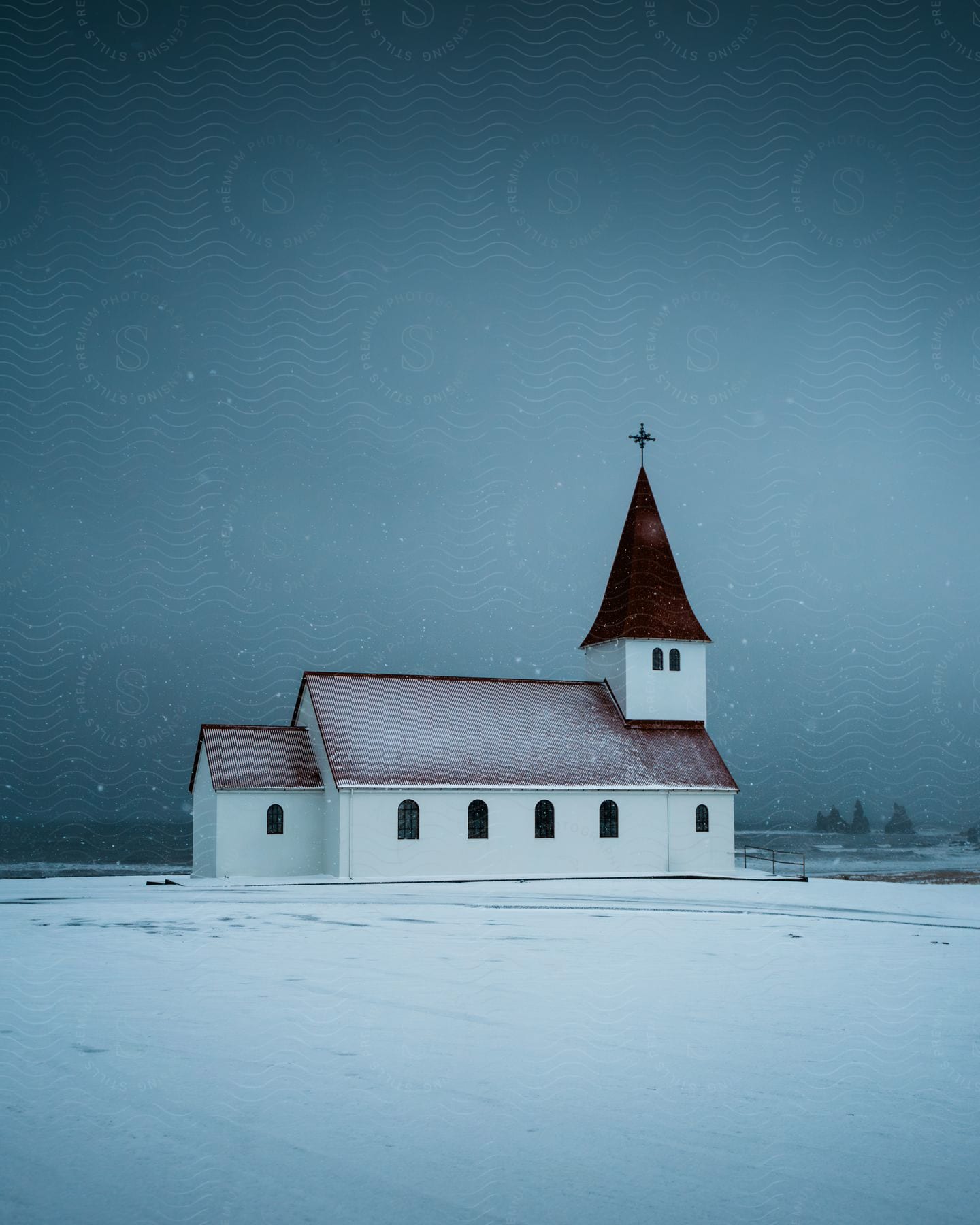 A View Of An Old Church Out In A Snowy Field