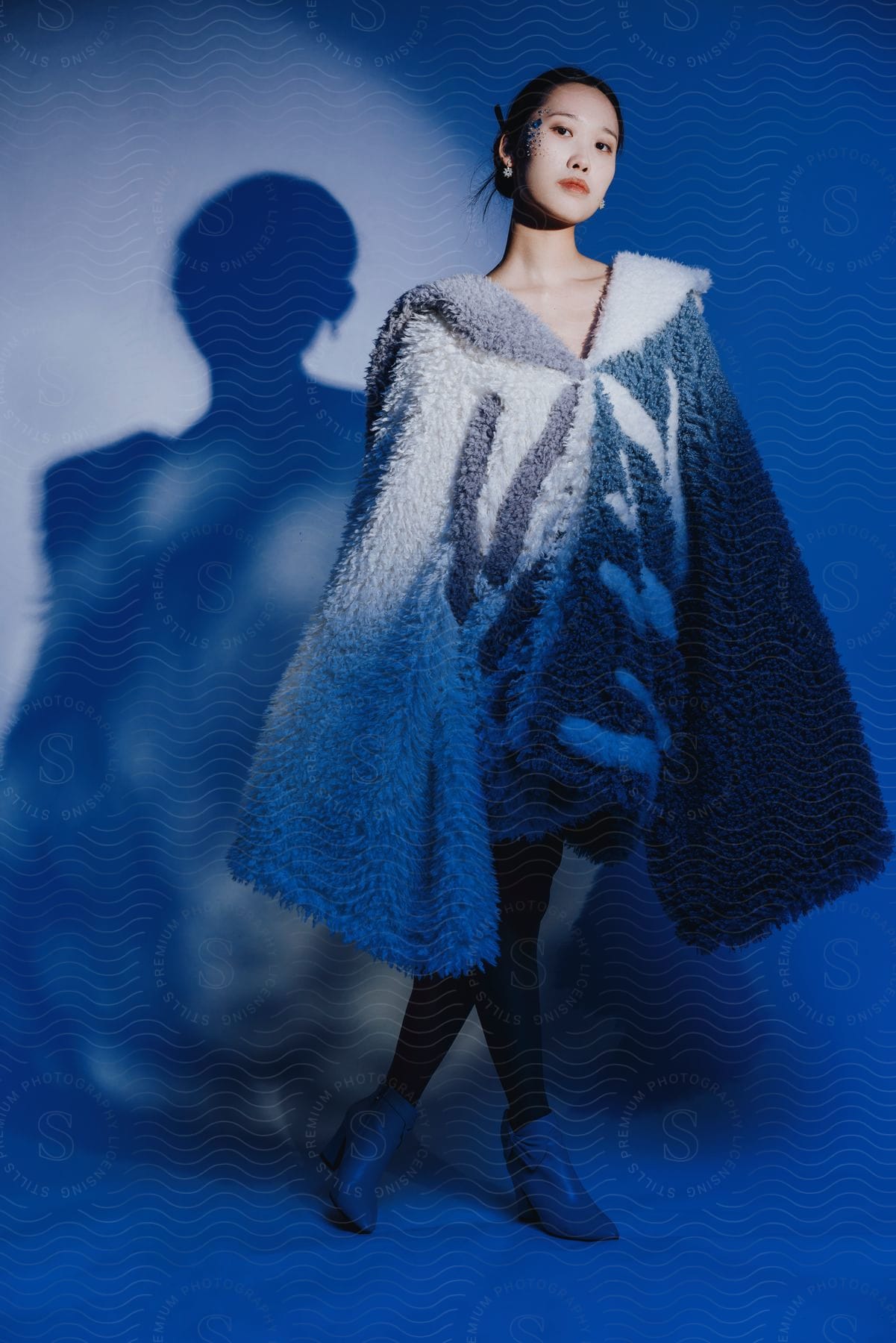 A woman looks ahead as she models a long sleeve wool coat