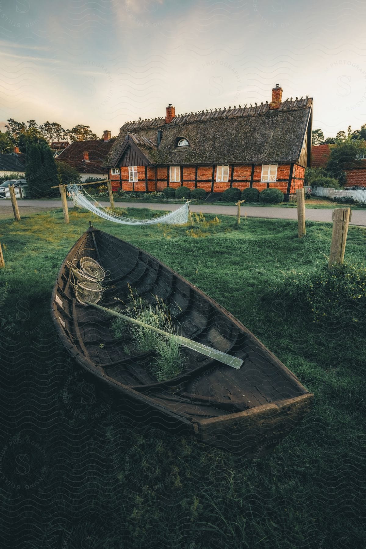 A boat sitting in a yard in front of a house.