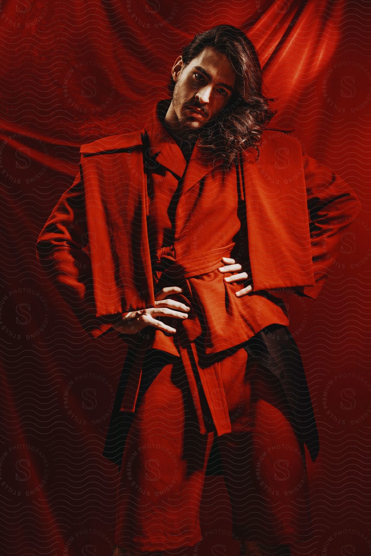 Model with long hair wearing red garments