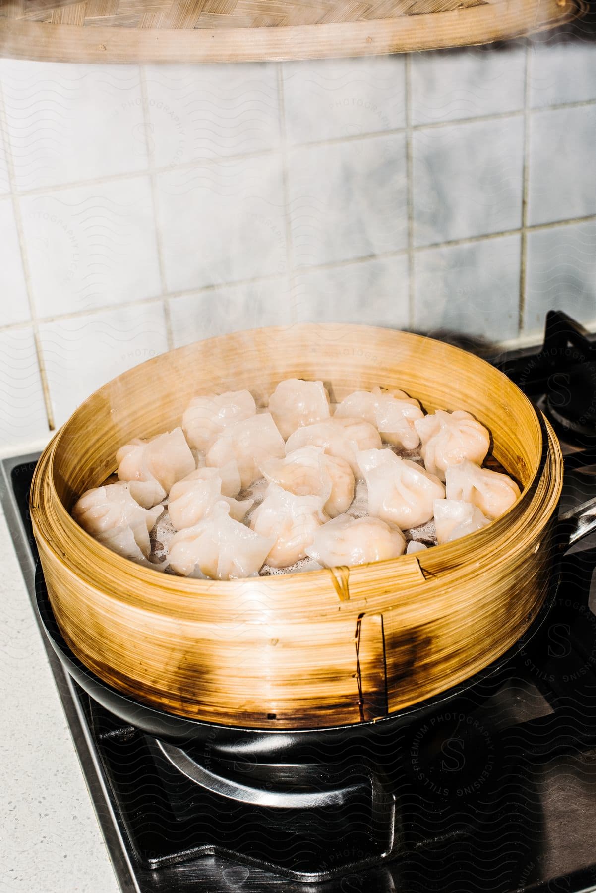 Dumplings are steaming on the stove.