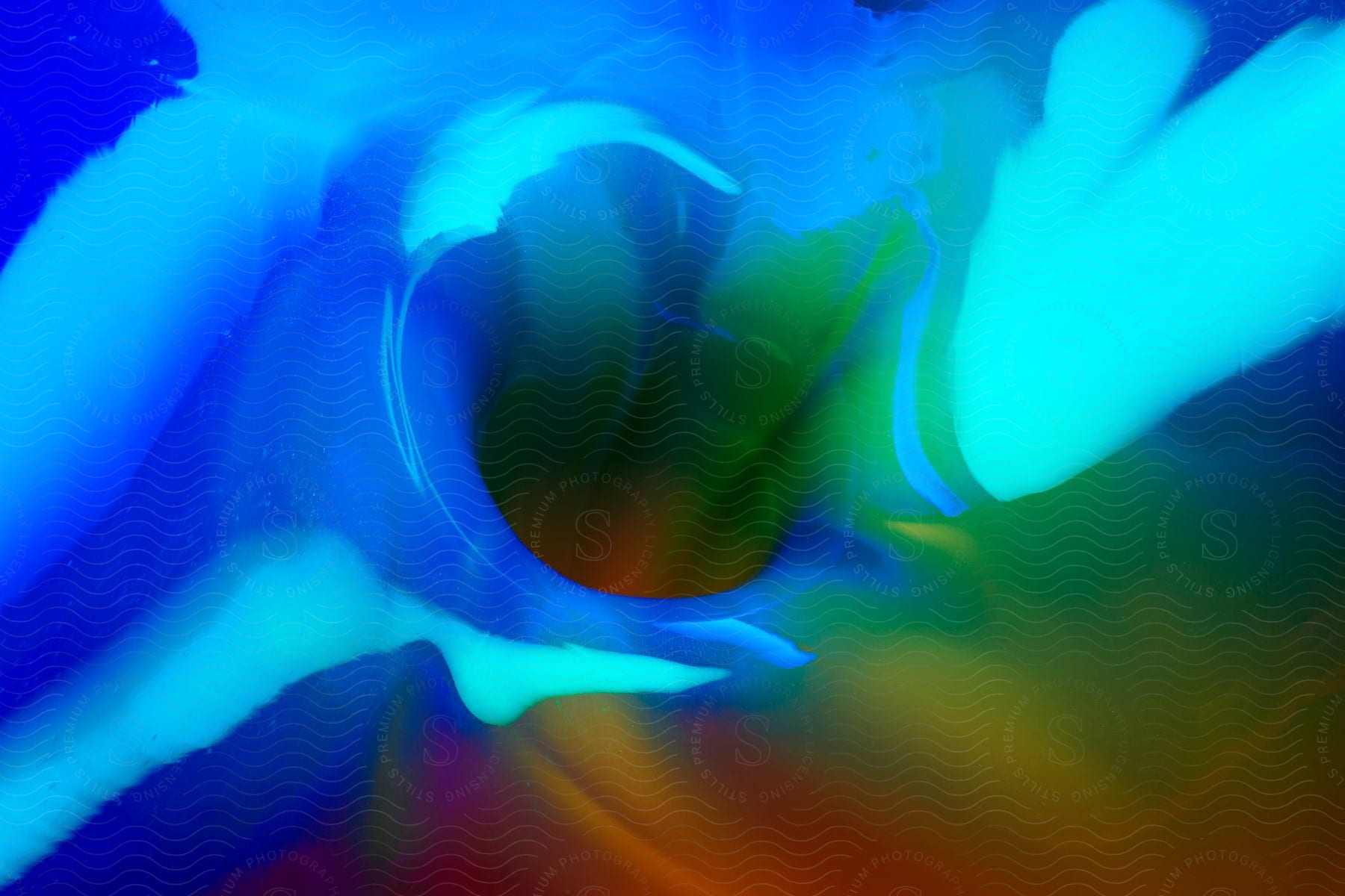 Close perspective of a vase with blue, green, red and yellow hues.