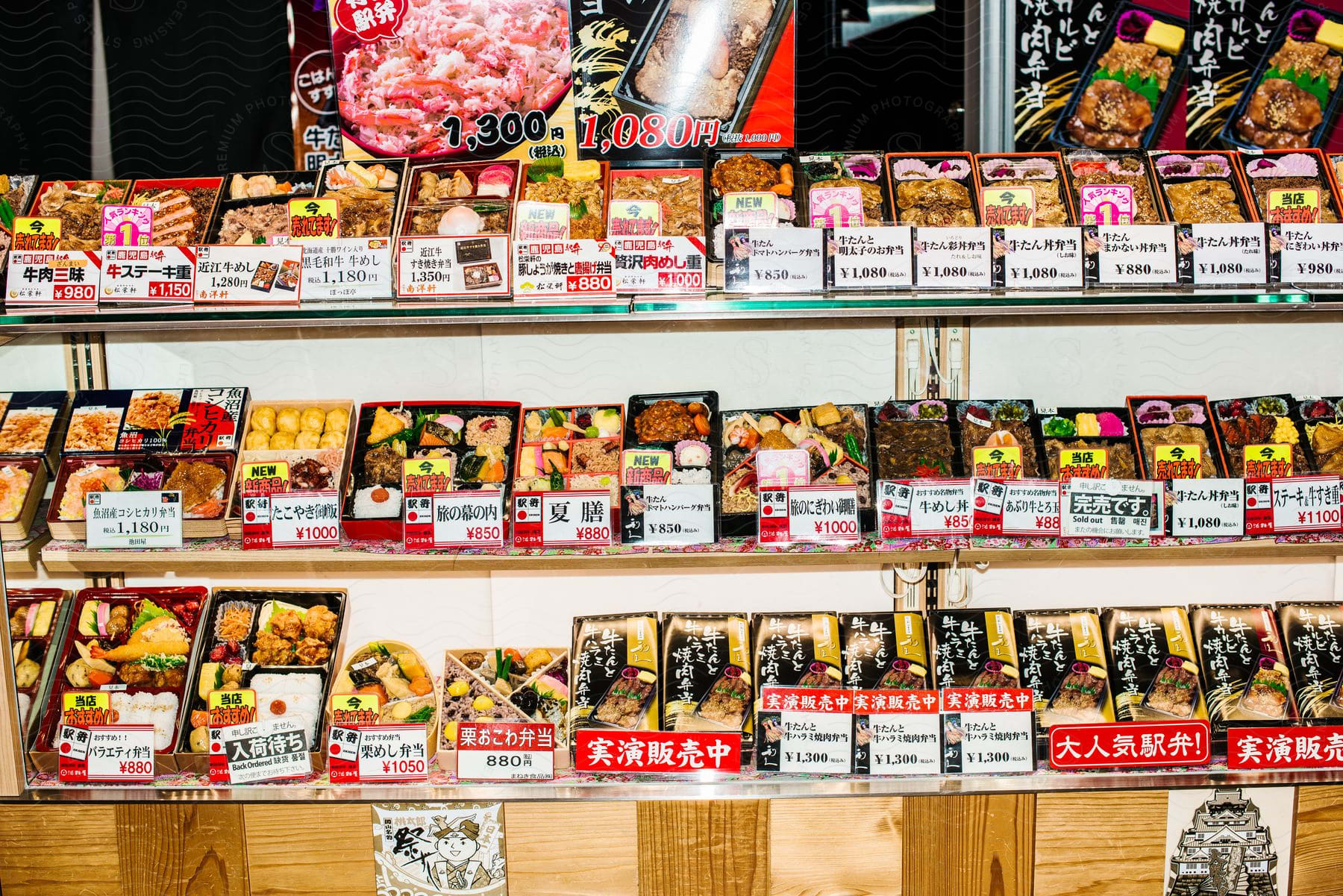 A lot of food sitting in a case in a store window.