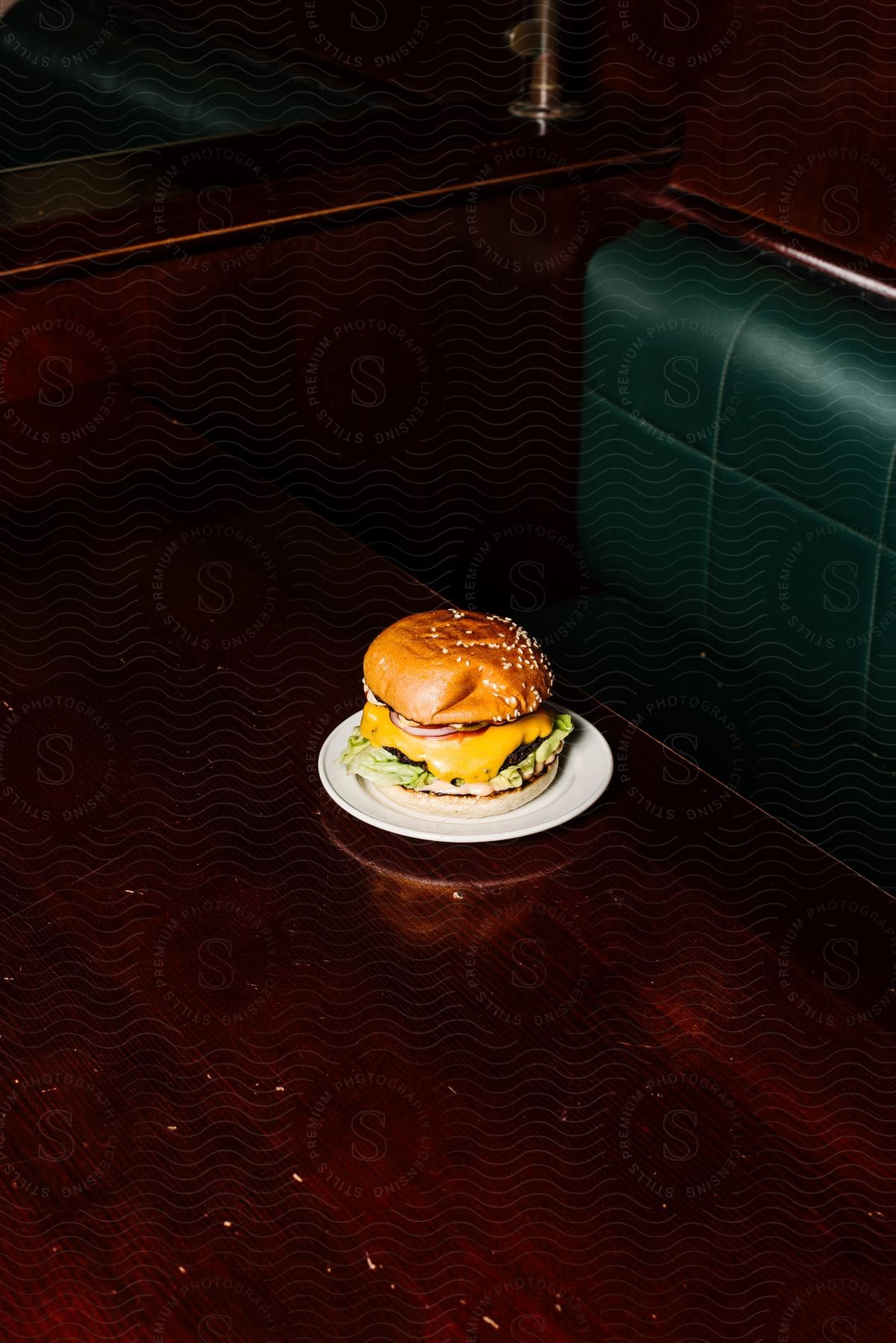 A cheeseburger on a restaurant table.