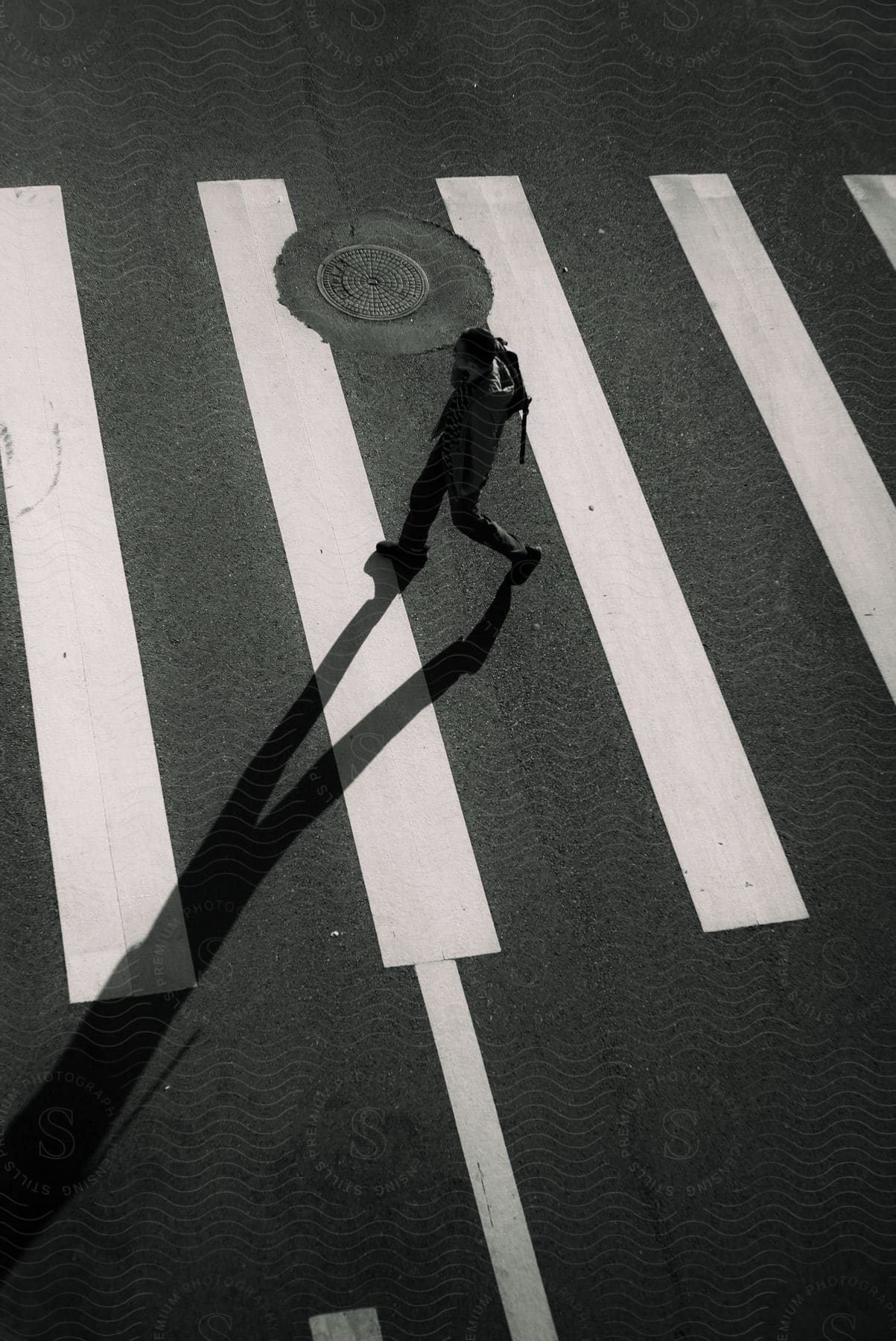 a man walks along a city crosswalk