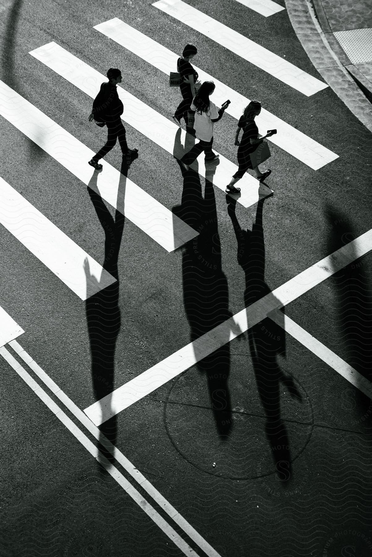 a group of people walk down a city crosswalk