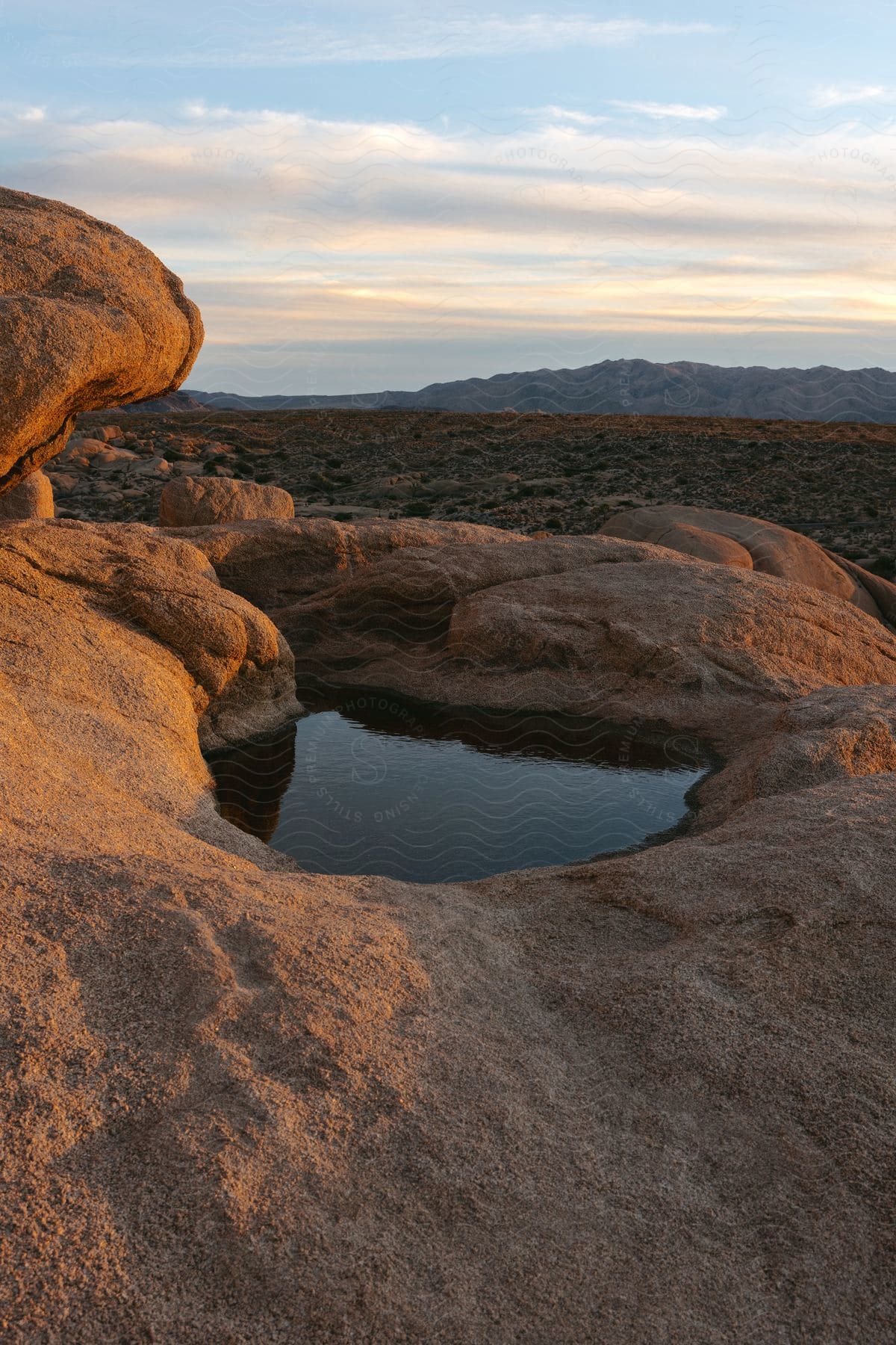 water sitting in a rocky terrain in the wilderness